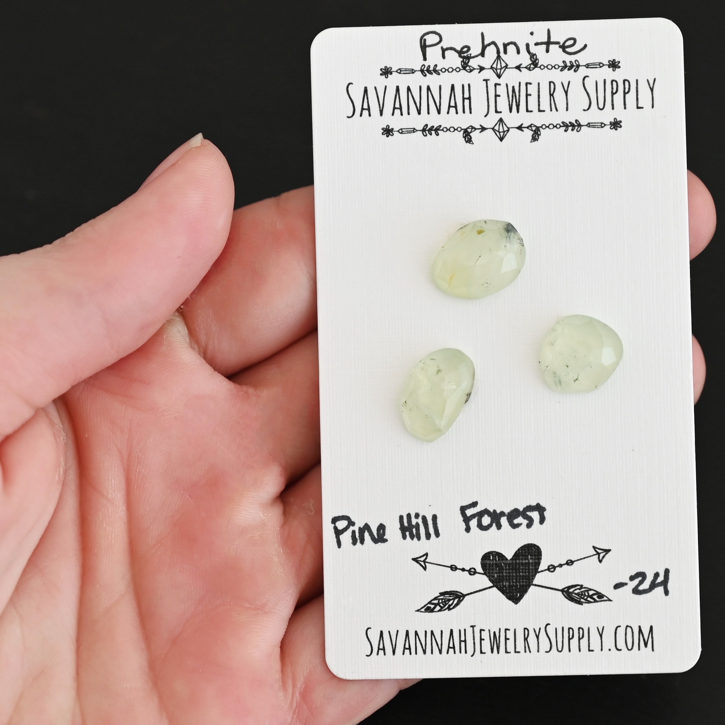 Pine Hill Forest Rose Cut Prehnite Cabochon Parcel shown in hand