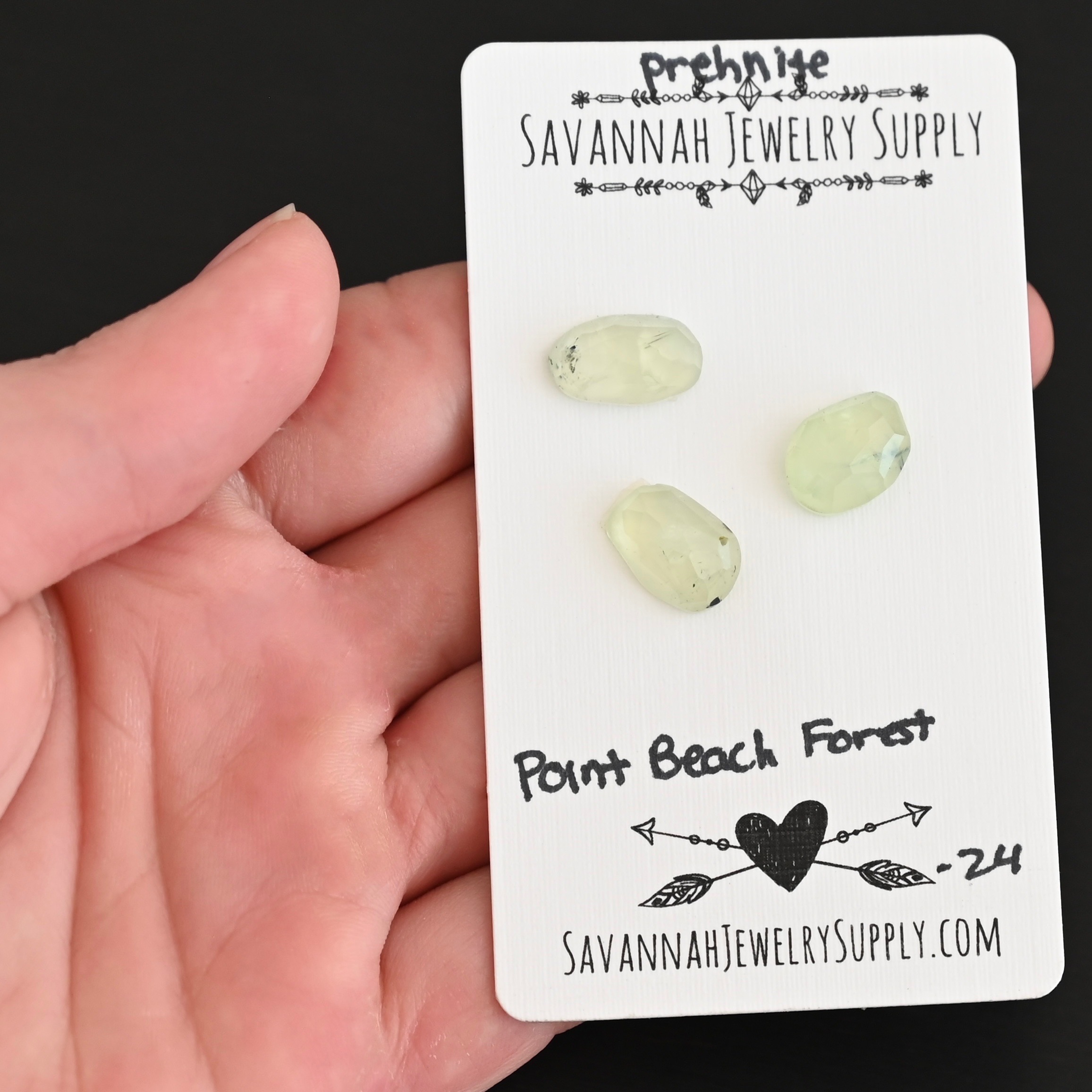 Point Beach Forest Rose Cut Prehnite Cabochon Parcel shown in hand