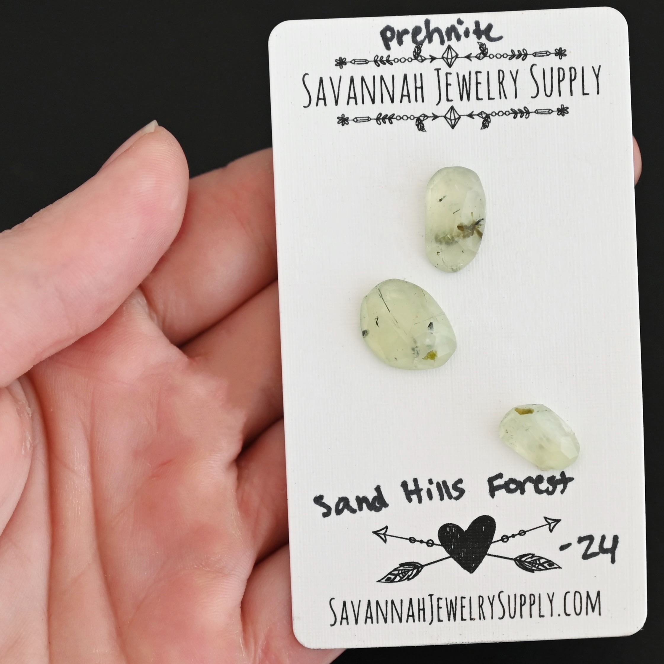 Sand Hills Forest Rose Cut Prehnite Cabochon Parcel shown in hand