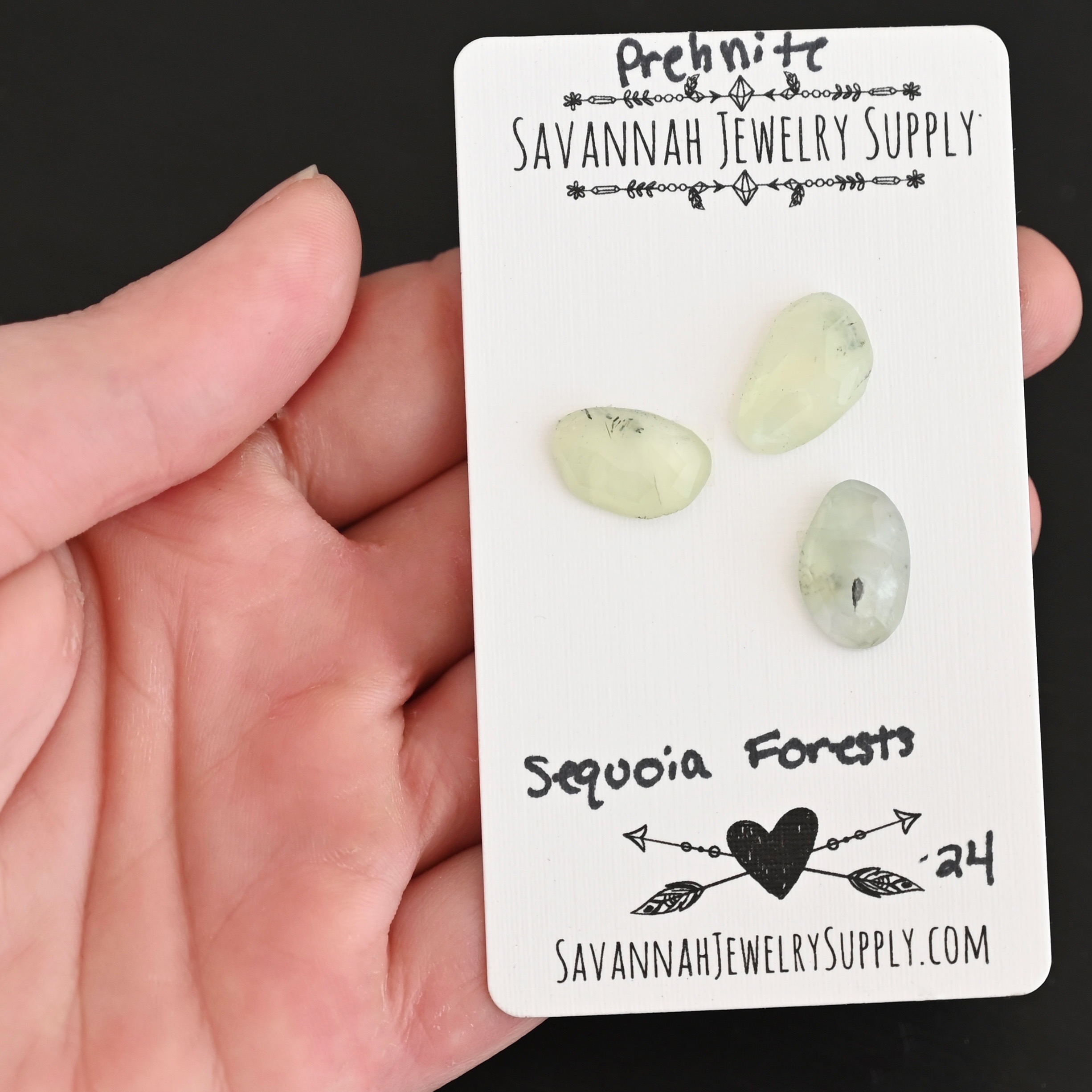 Sequoia Forest Rose Cut Prehnite Cabochon Parcel shown in hand