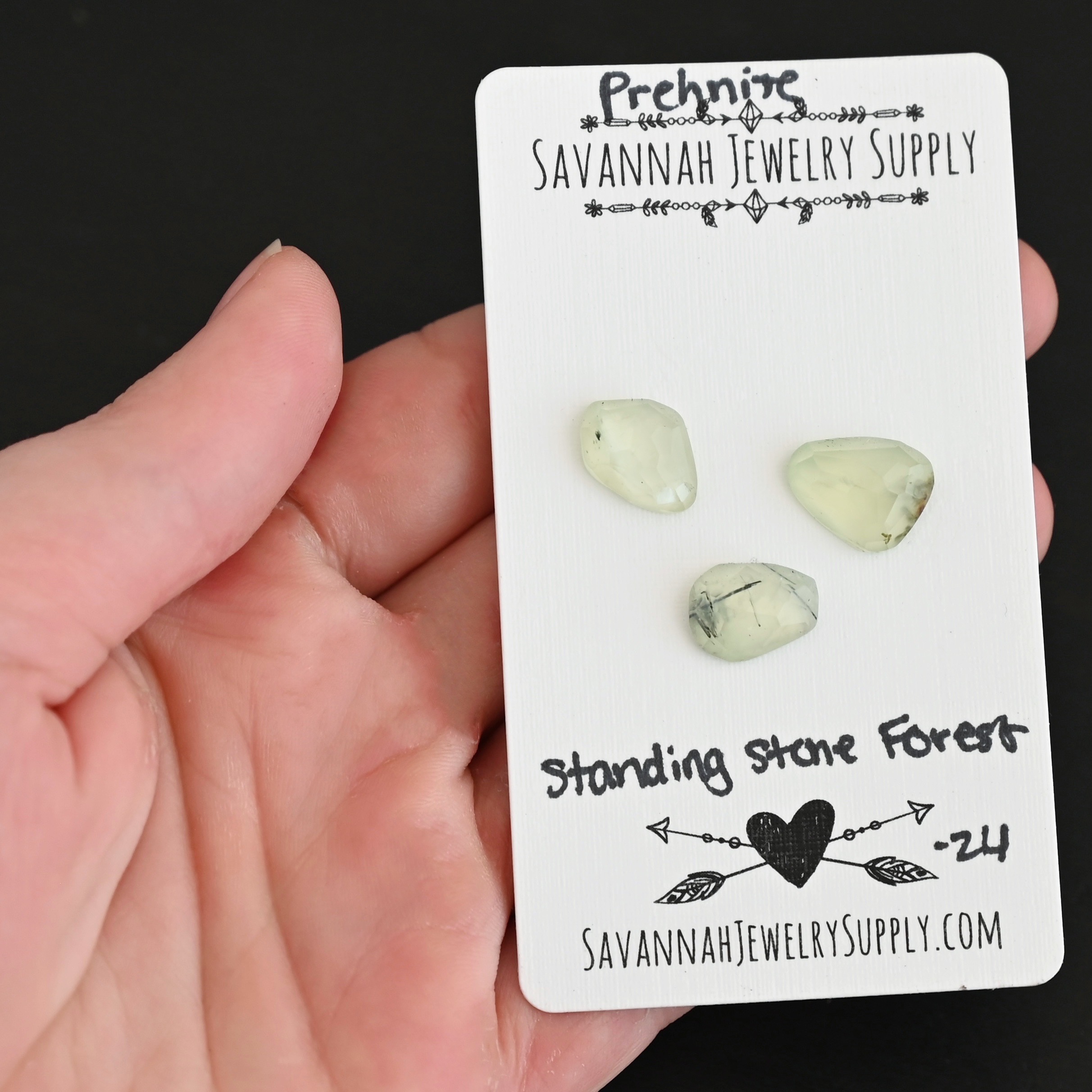 Standing Stone Forest Rose Cut Prehnite Cabochon Parcel shown in hand