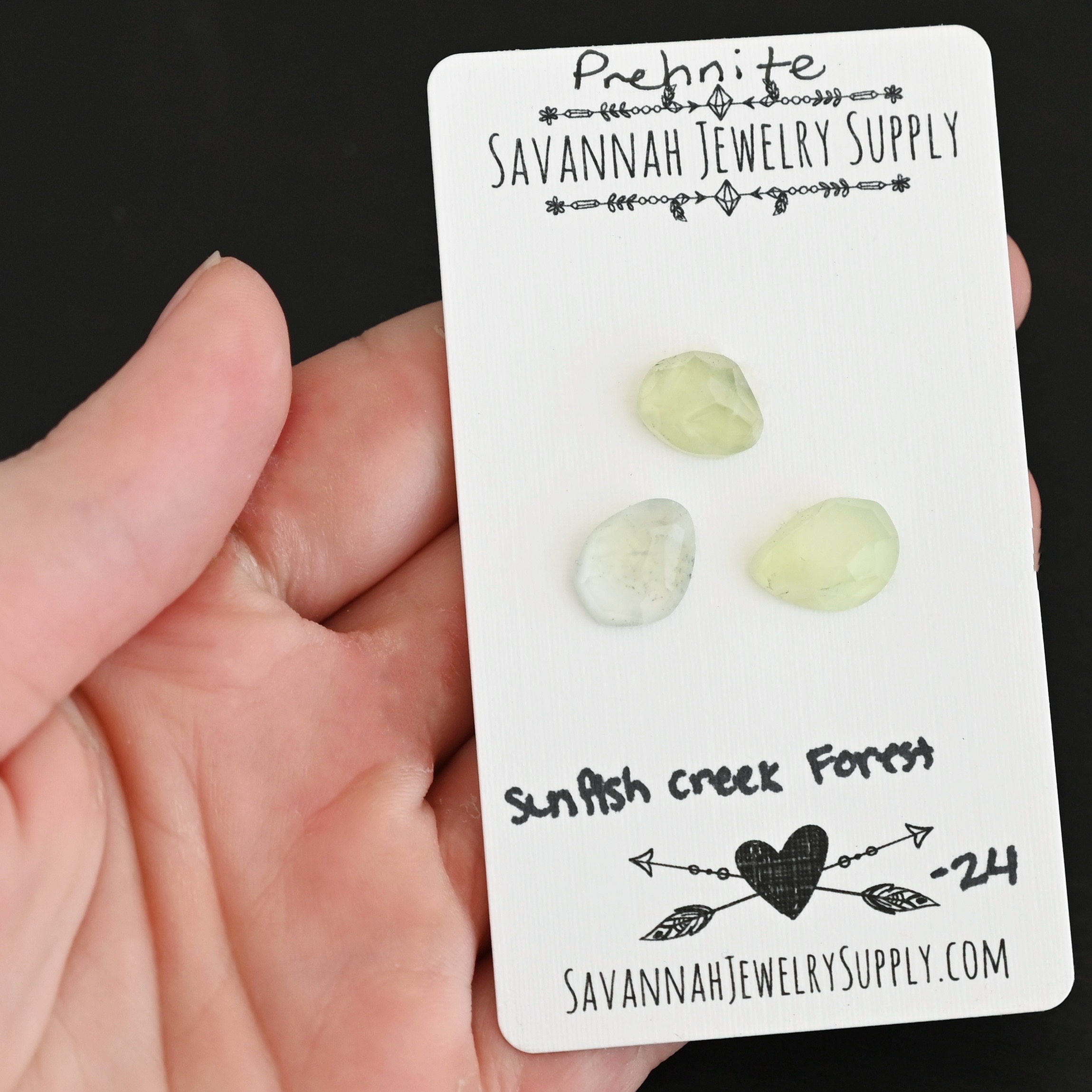 Sunfish Creek Forest Rose Cut Prehnite Cabochon Parcel shown in hand