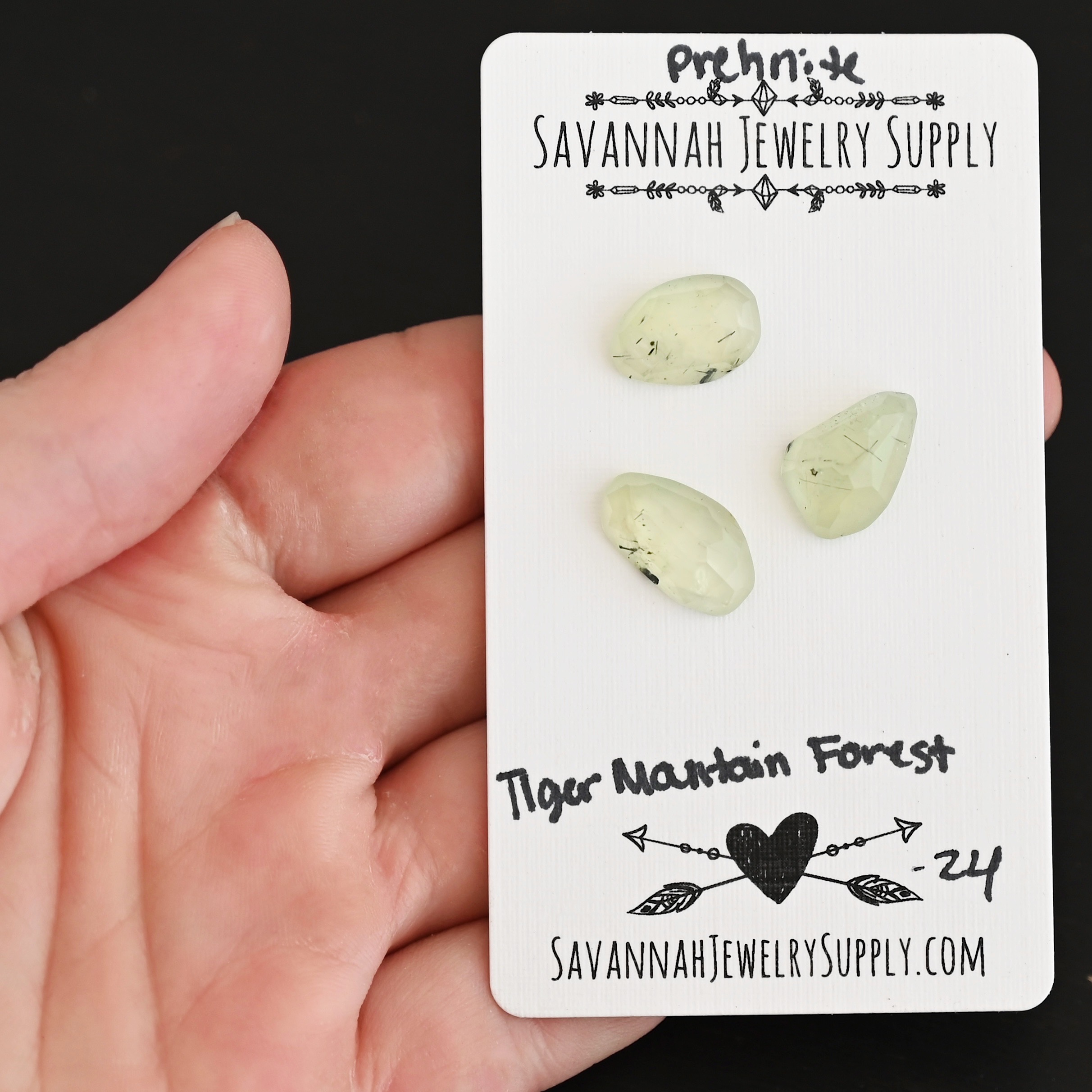 Tiger Mountain Forest Rose Cut Prehnite Cabochon Parcel shown in hand