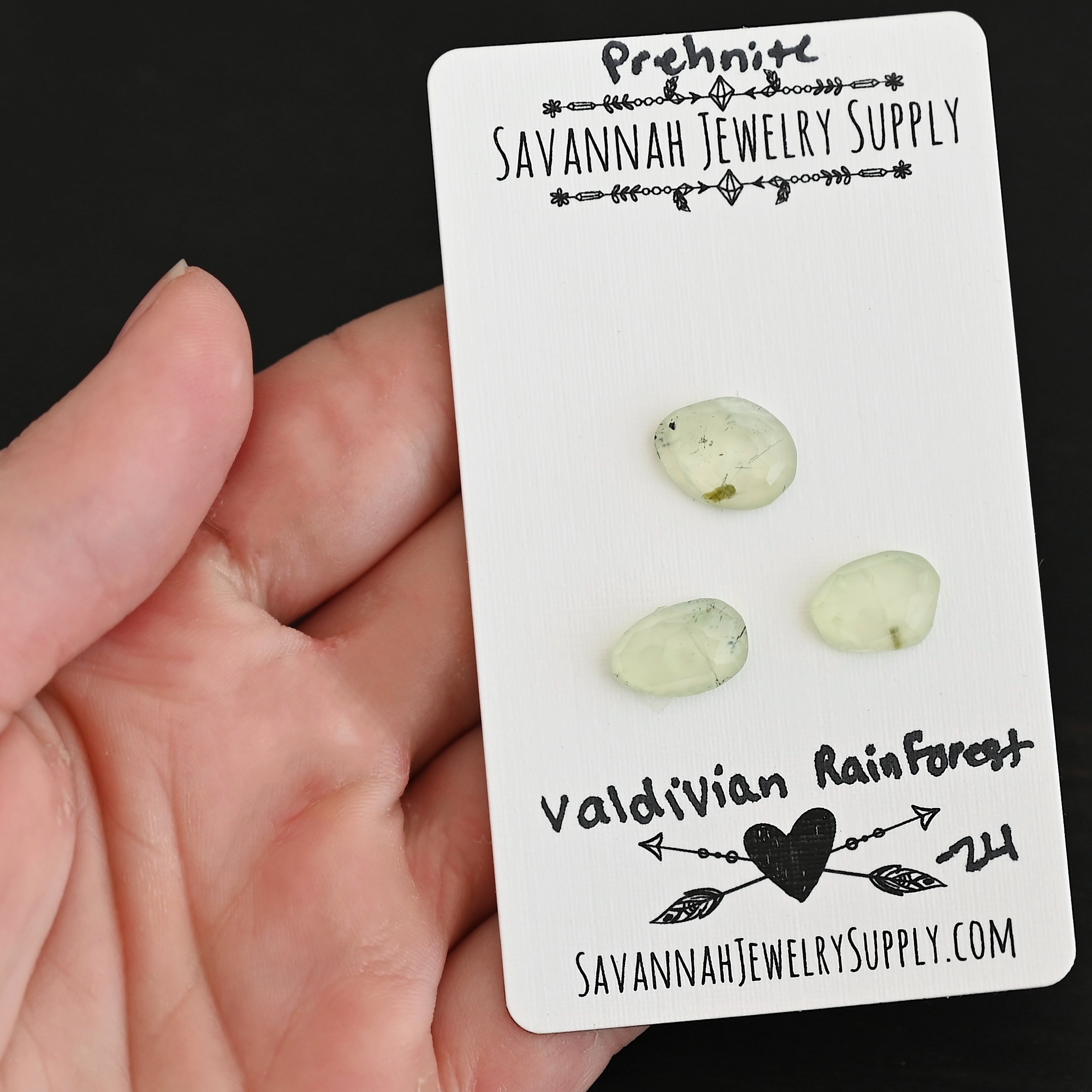 Valdivian Forest Rose Cut Prehnite Cabochon Parcel shown in hand