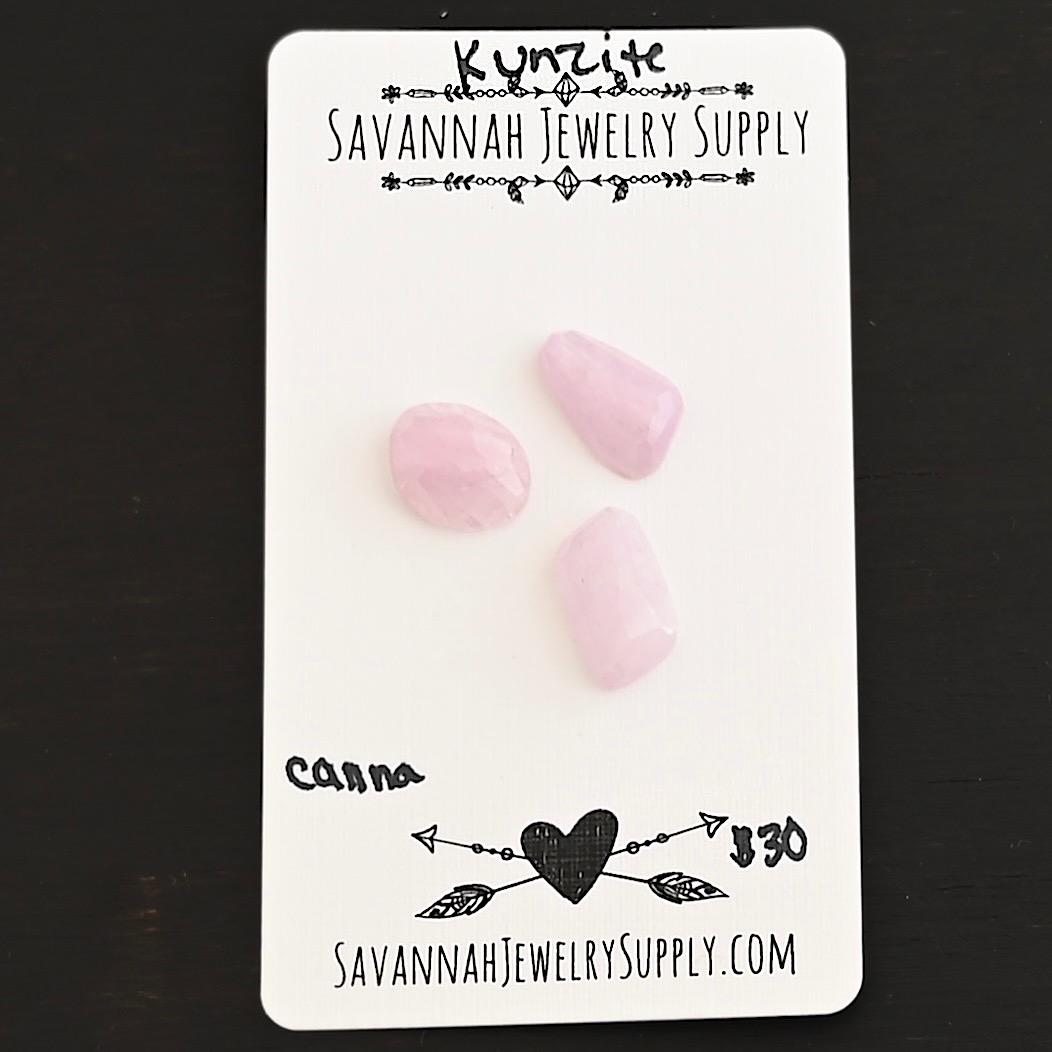 Canna Rose Cut Kunzite Cabochon Parcel shown on business card