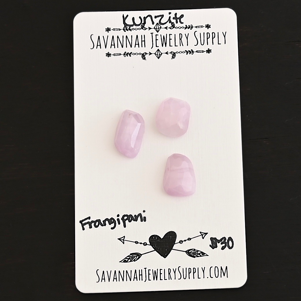 Frangipani Rose Cut Kunzite Cabochon Parcel shown on business card