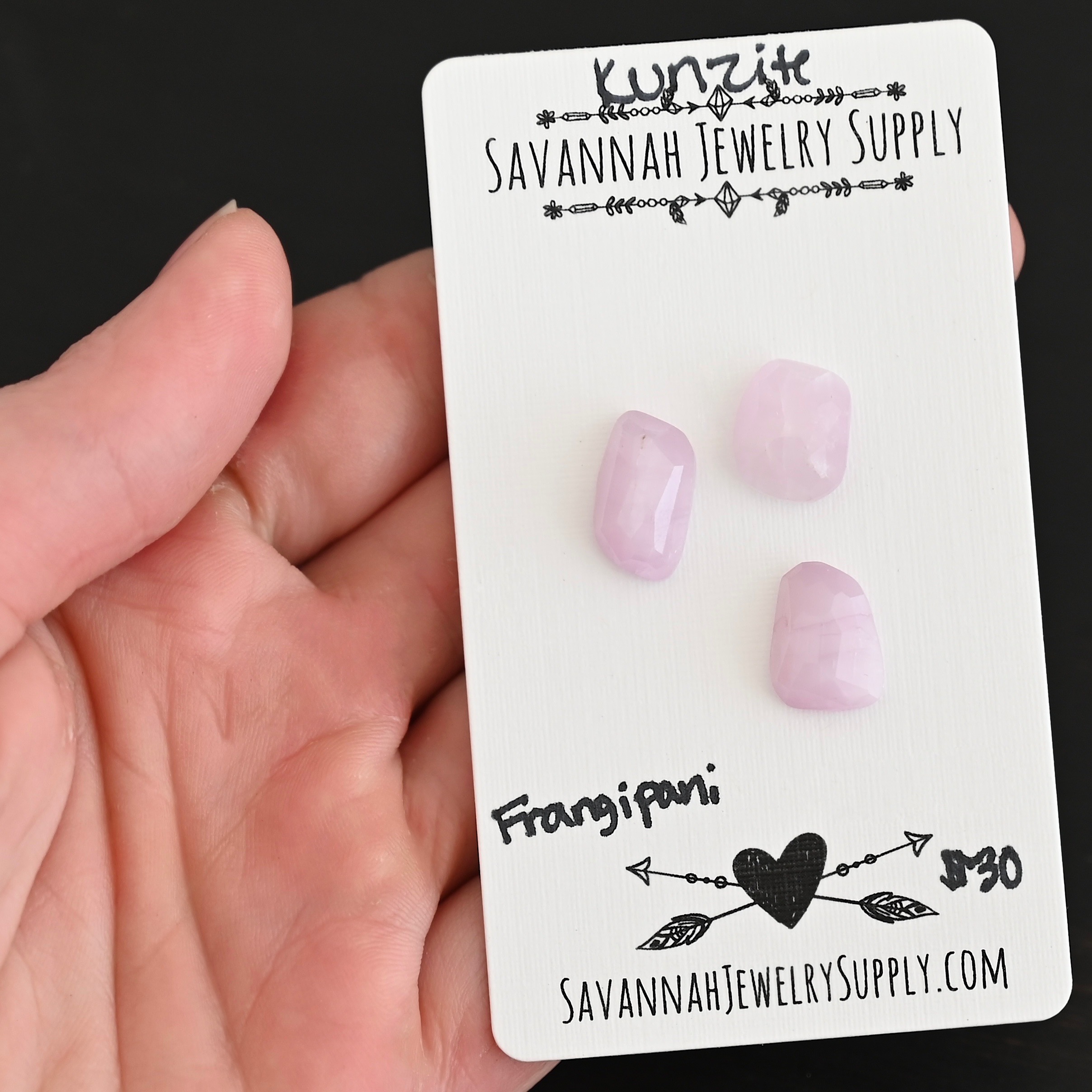 Frangipani Rose Cut Kunzite Cabochon Parcel shown in hand