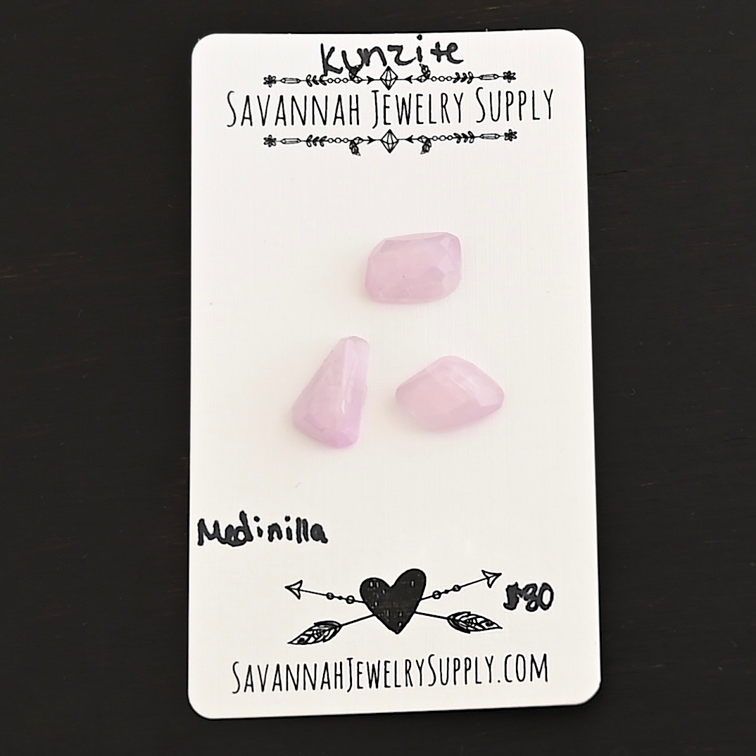 Medinilla Rose Cut Kunzite Cabochon Parcel shown on business card
