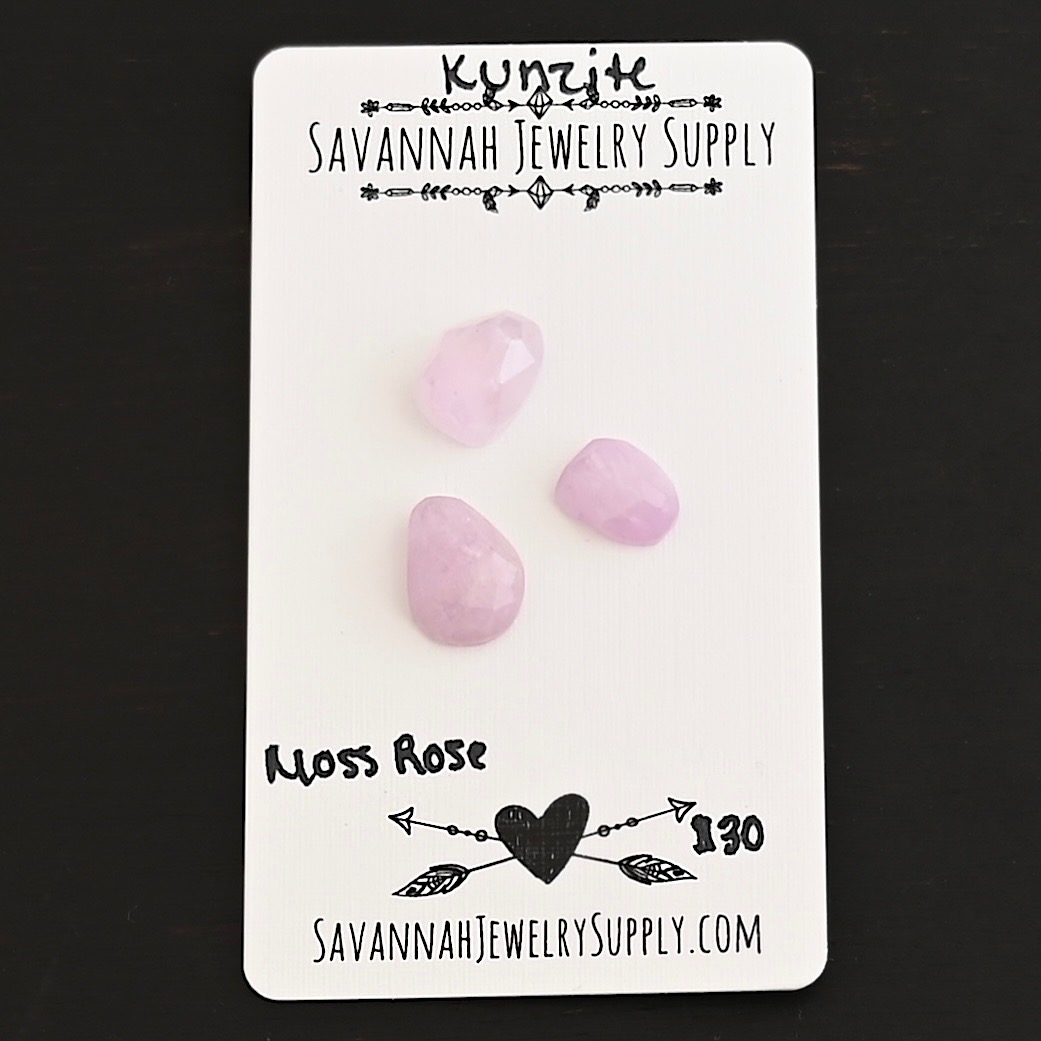 Moss Rose Rose Cut Kunzite Cabochon Parcel shown on business card