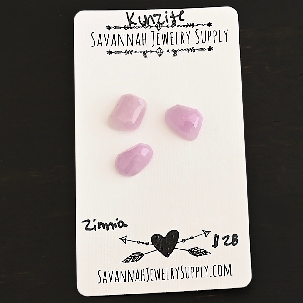 Zinnia Rose Cut Kunzite Cabochon Parcel shown on business card