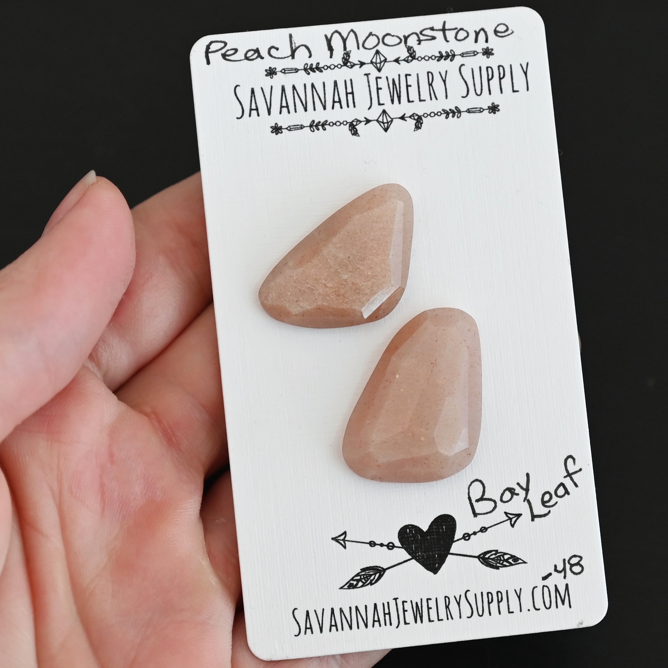 Bay Leaf Rose Cut Peach Moonstone Cabochon Parcel shown in hand