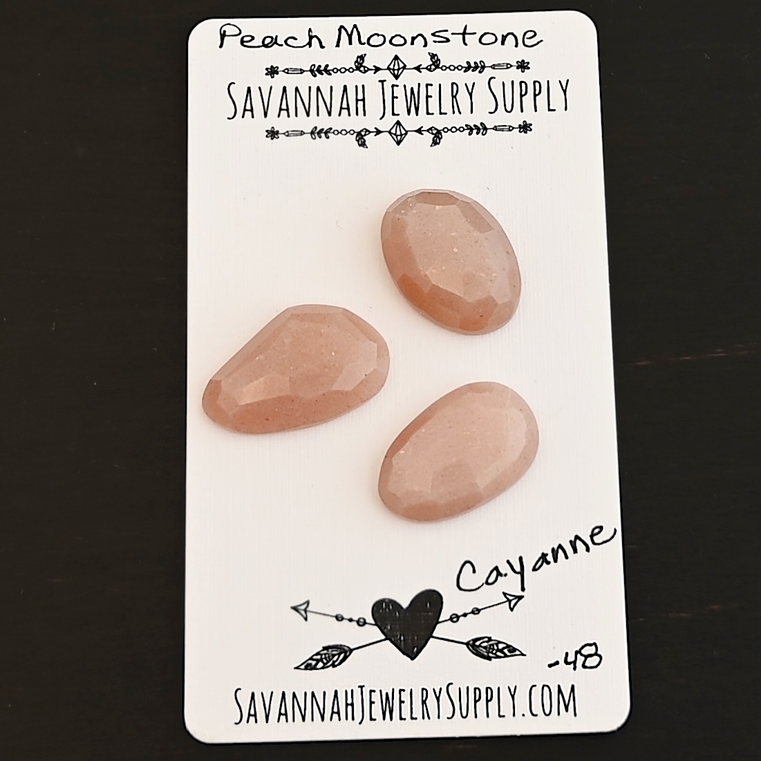Cayenne Rose Cut Peach Moonstone Cabochon Parcel shown on business card