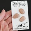 Cayenne Rose Cut Peach Moonstone Cabochon Parcel shown in hand