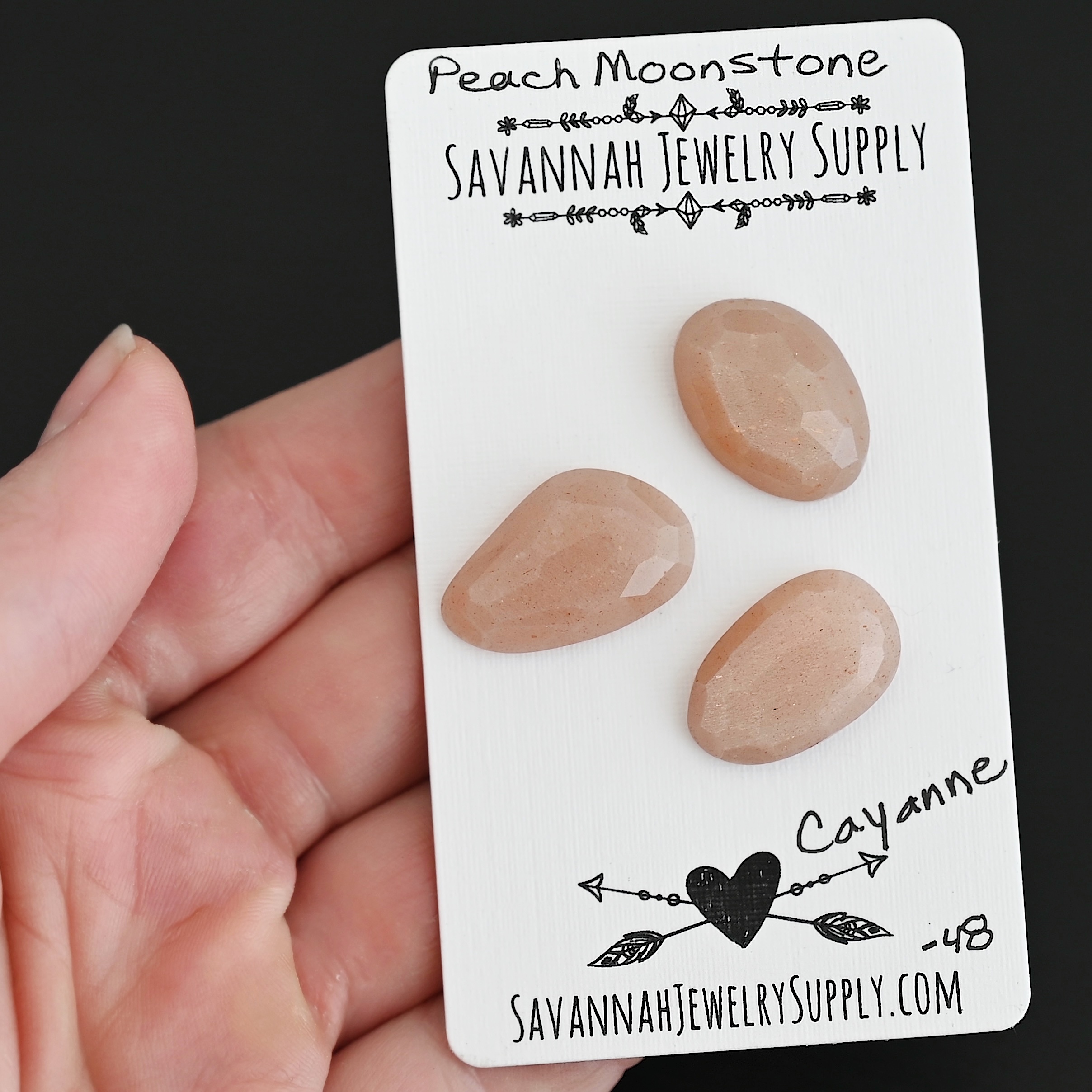 Cayenne Rose Cut Peach Moonstone Cabochon Parcel shown in hand