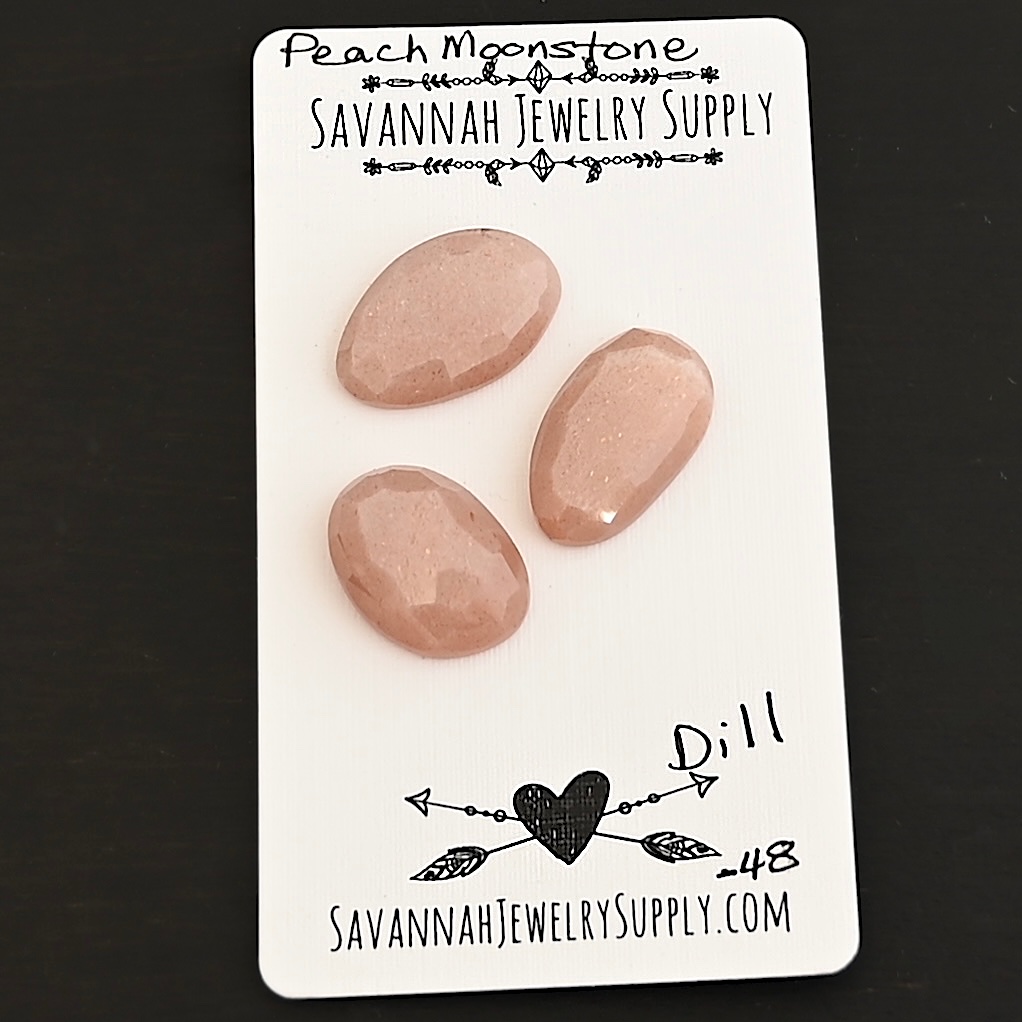 Dill Rose Cut Peach Moonstone Cabochon Parcel shown on business card