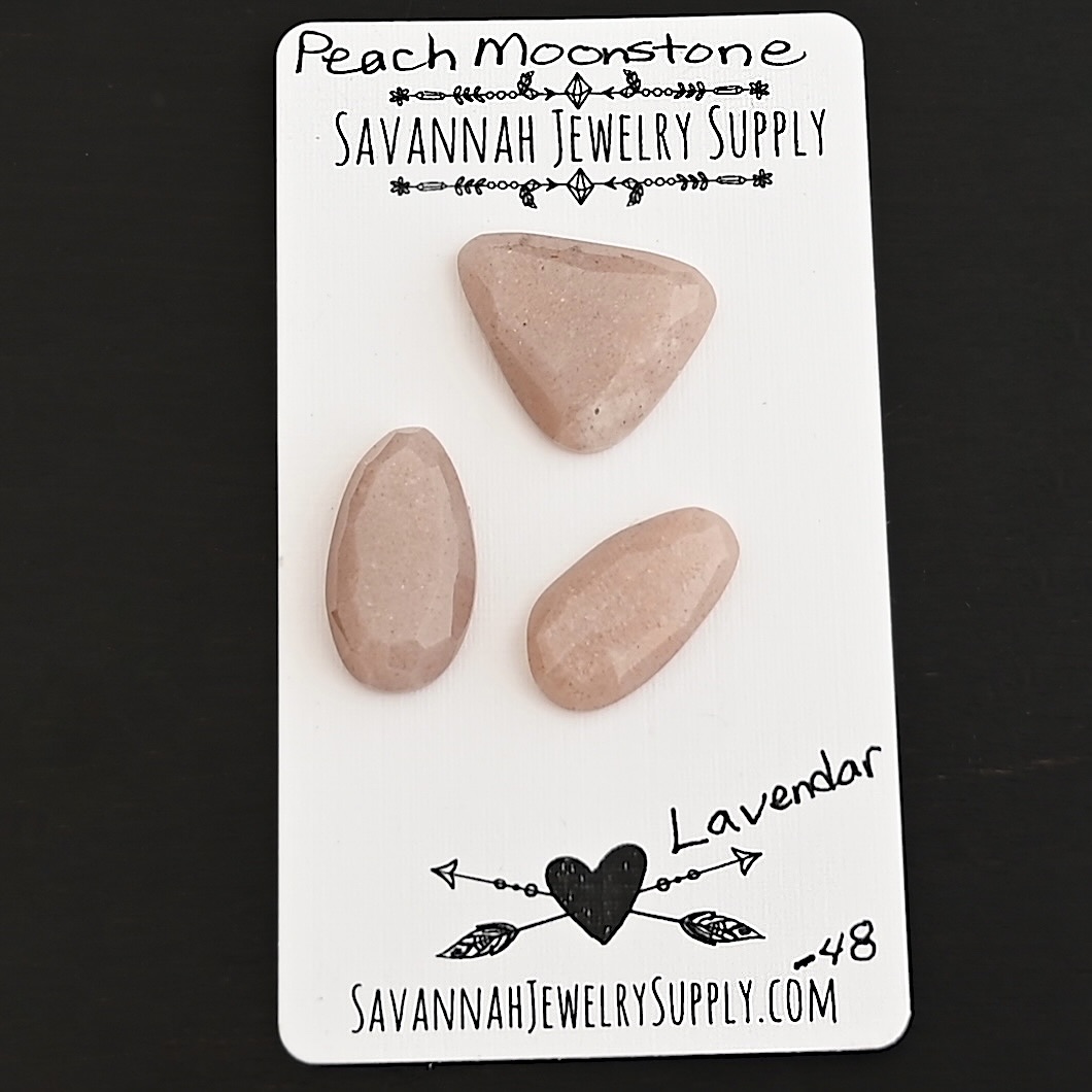 Lavender Rose Cut Peach Moonstone Cabochon Parcel shown on business card