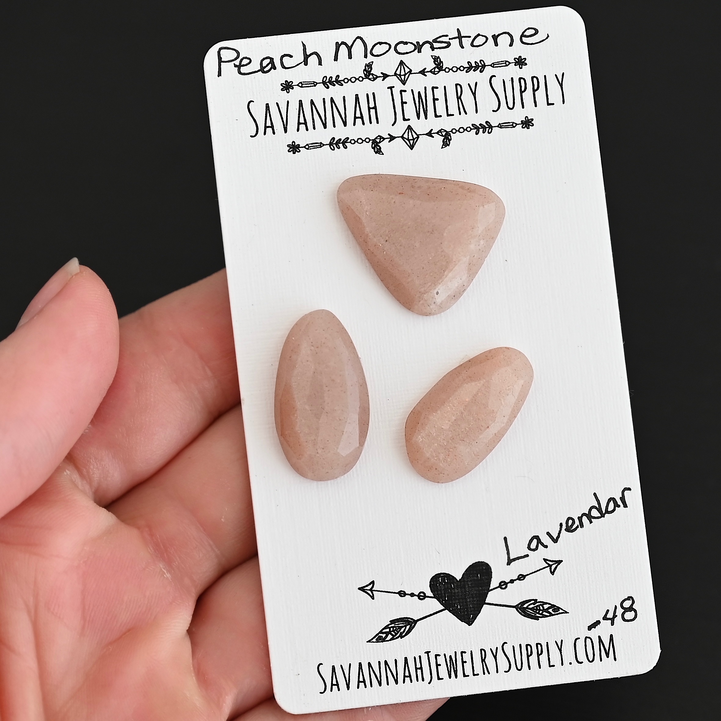 Lavender Rose Cut Peach Moonstone Cabochon Parcel shown in hand