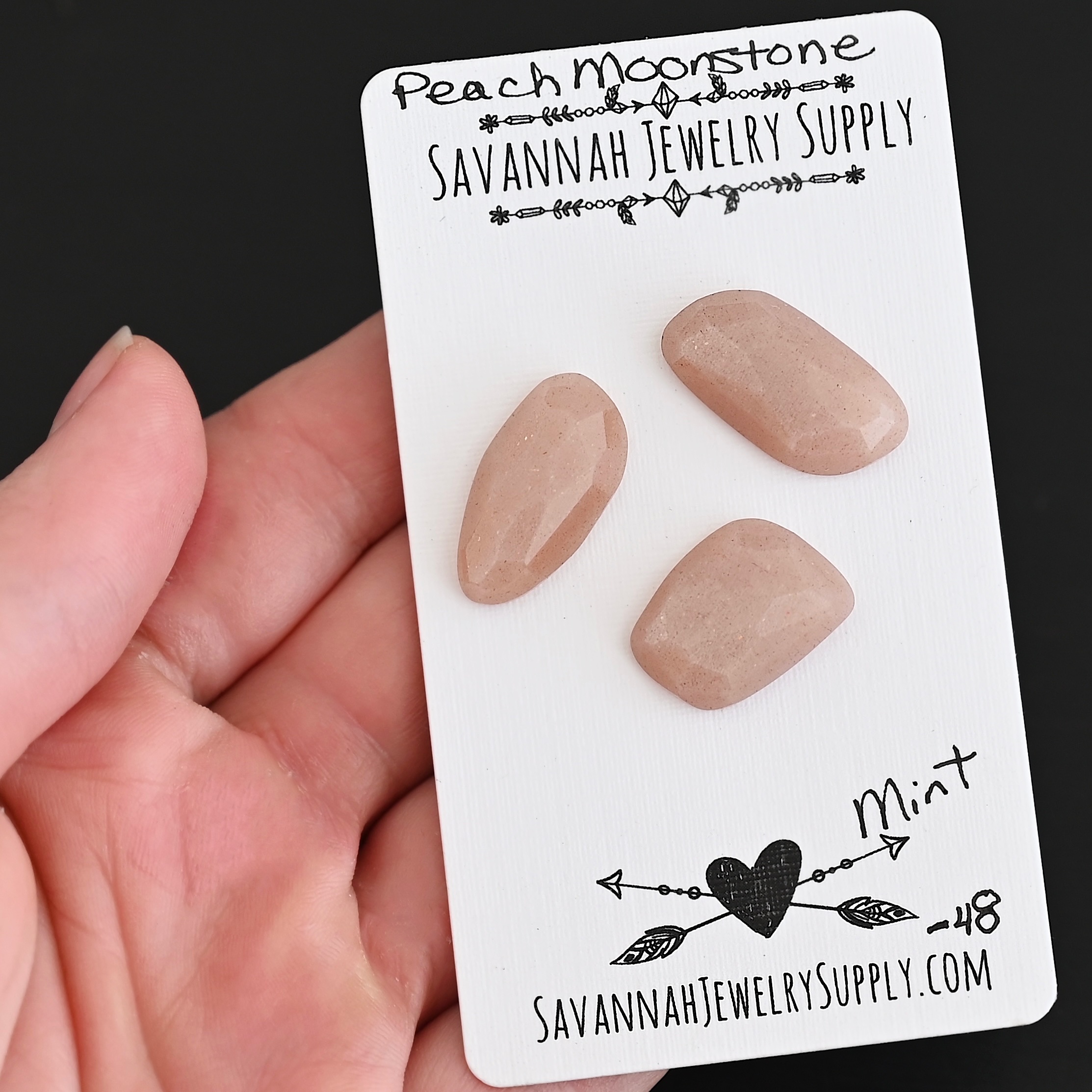 Mint Rose Cut Peach Moonstone Cabochon Parcel shown in hand