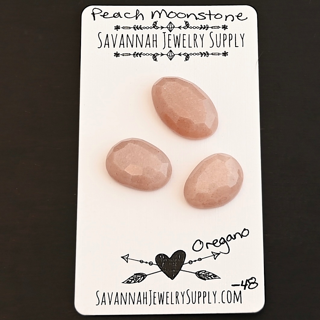 Oregano Rose Cut Peach Moonstone Cabochon Parcel shown on business card