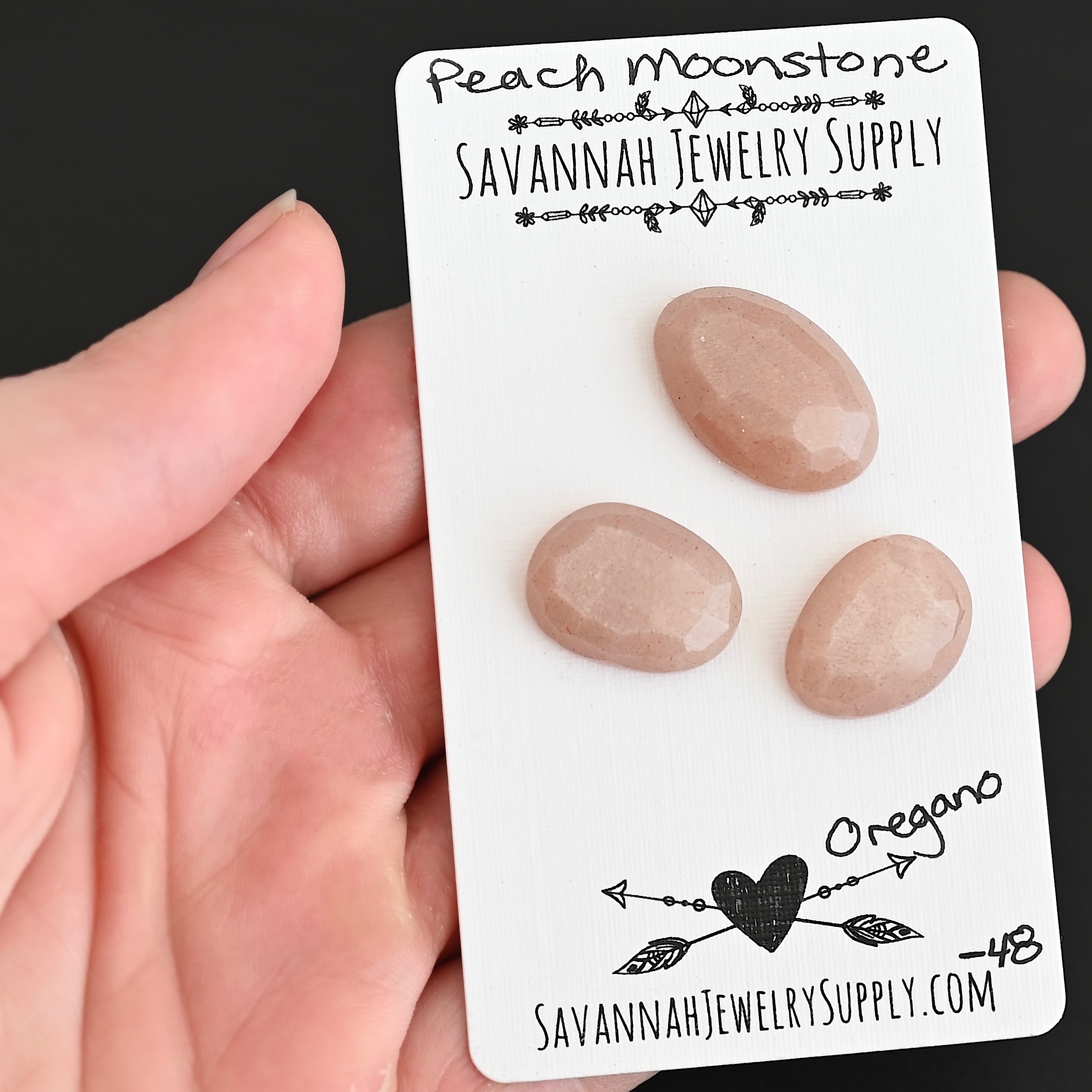 Oregano Rose Cut Peach Moonstone Cabochon Parcel shown in hand