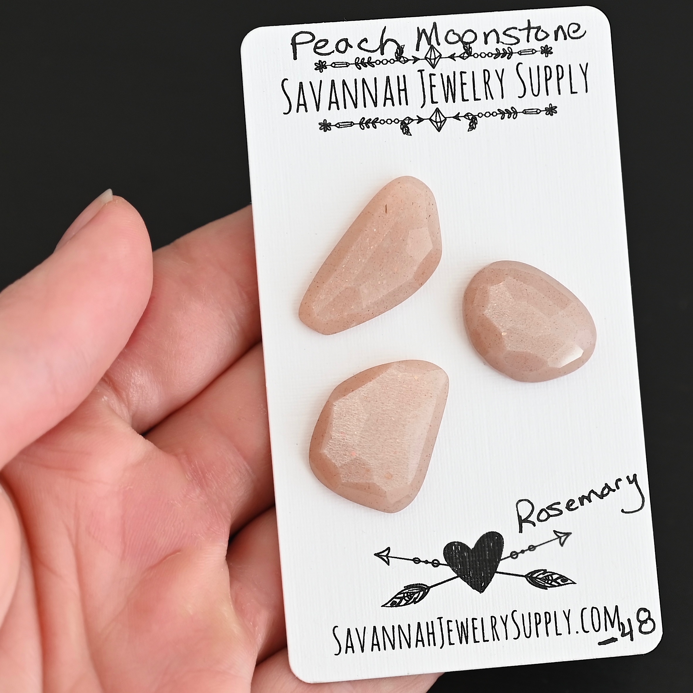Rosemary Rose Cut Peach Moonstone Cabochon Parcel shown in hand