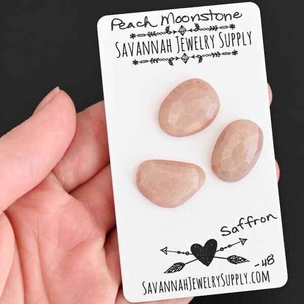 Saffron Rose Cut Peach Moonstone Cabochon Parcel shown in hand