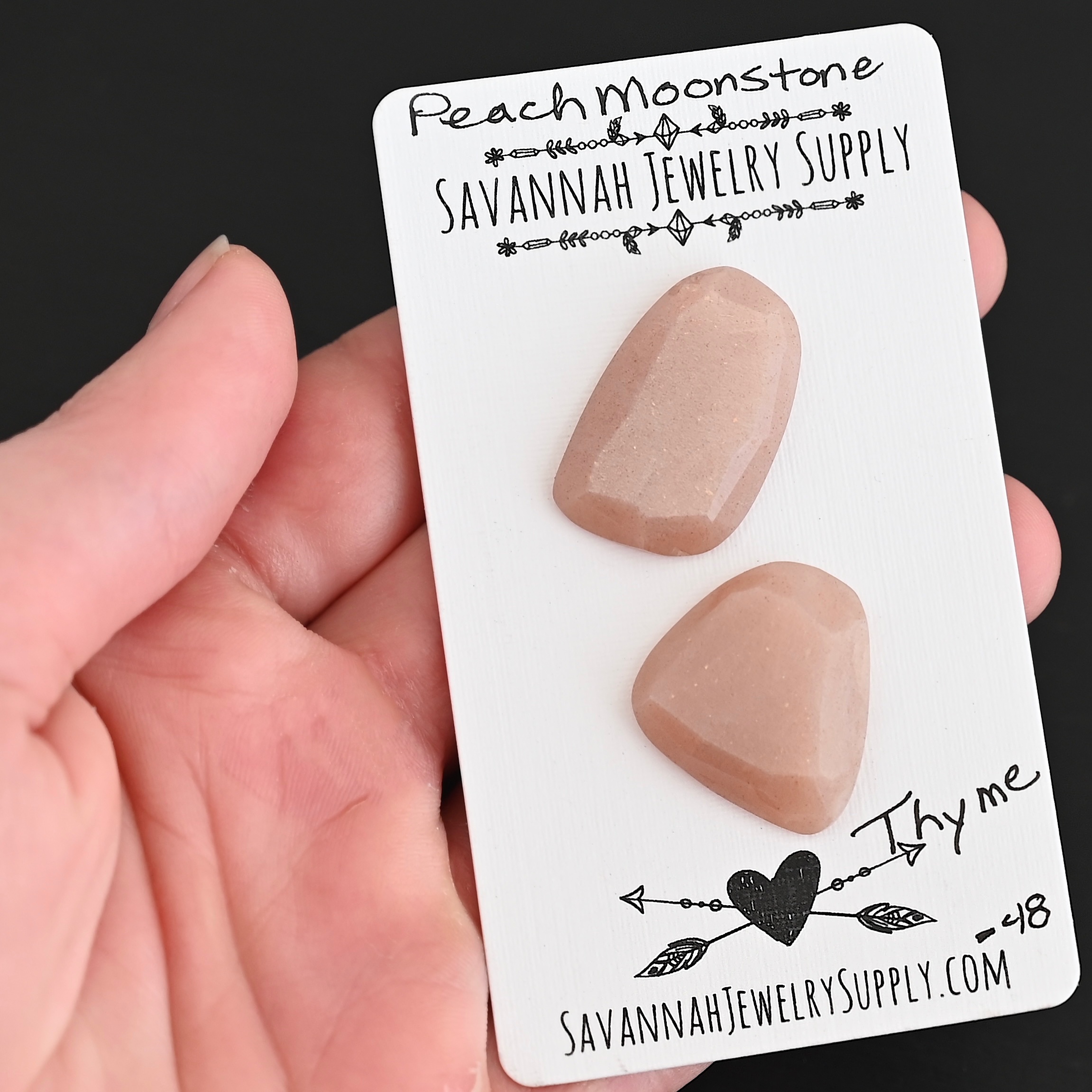 Thyme Rose Cut Peach Moonstone Cabochon Parcel shown in hand