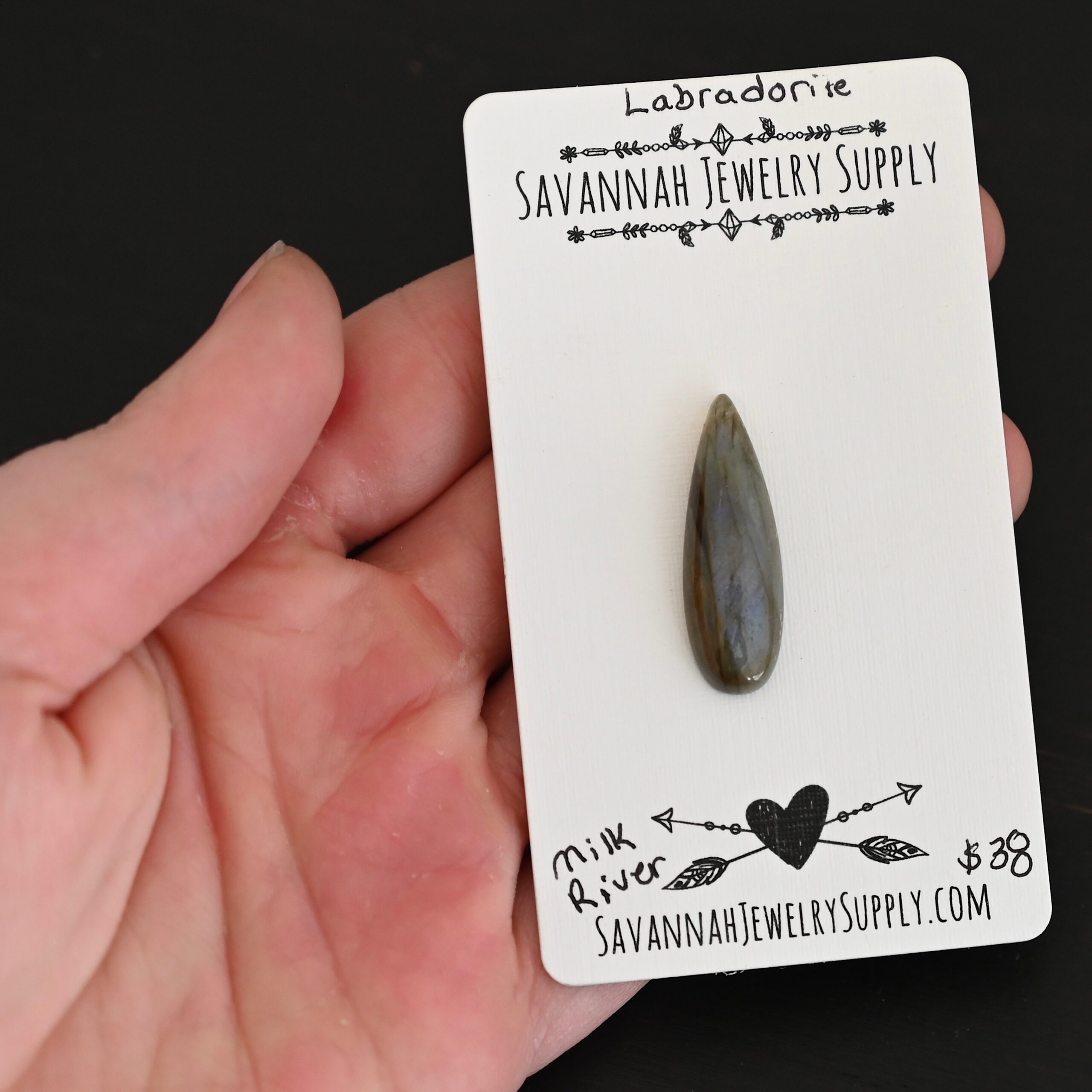 Milk River Labradorite Cabochon Parcel shown in hand