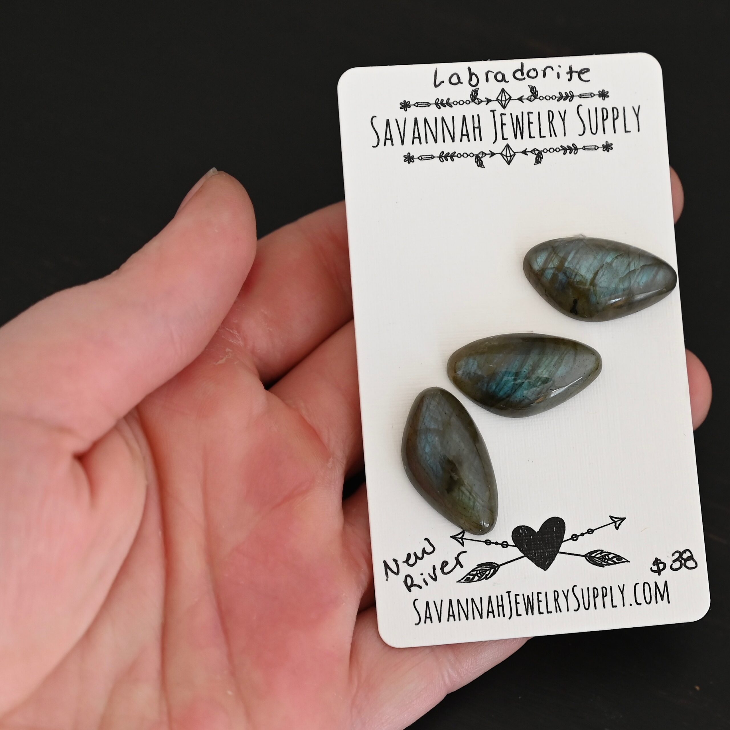 New River Labradorite Cabochon Parcel shown in hand