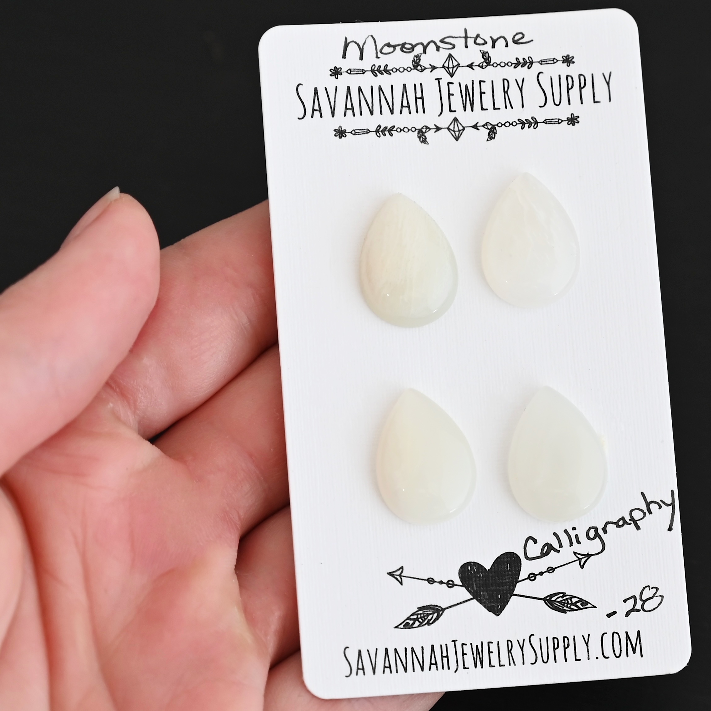 Calligraphy Moonstone Cabochon Parcel shown in hand