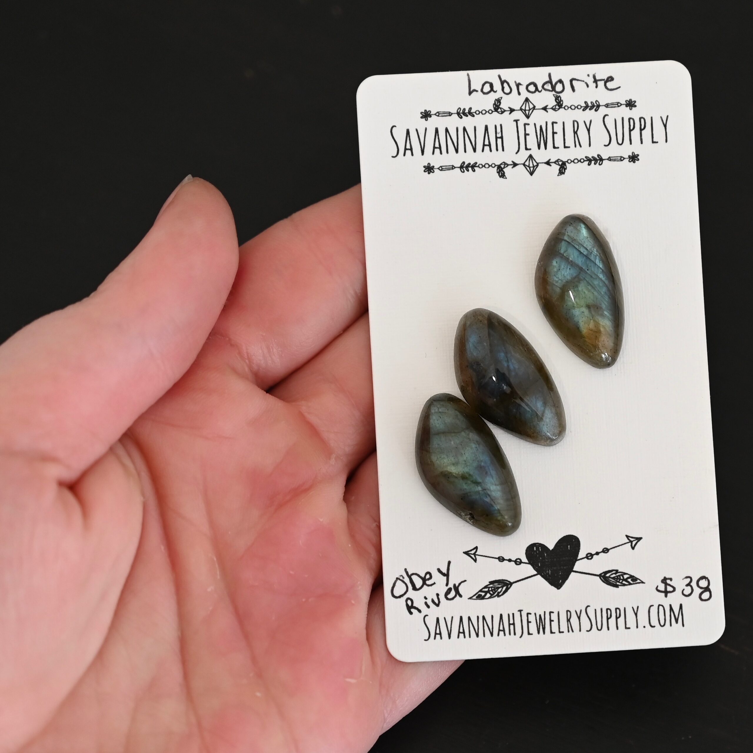 Obey River Labradorite Cabochon Parcel shown in hand