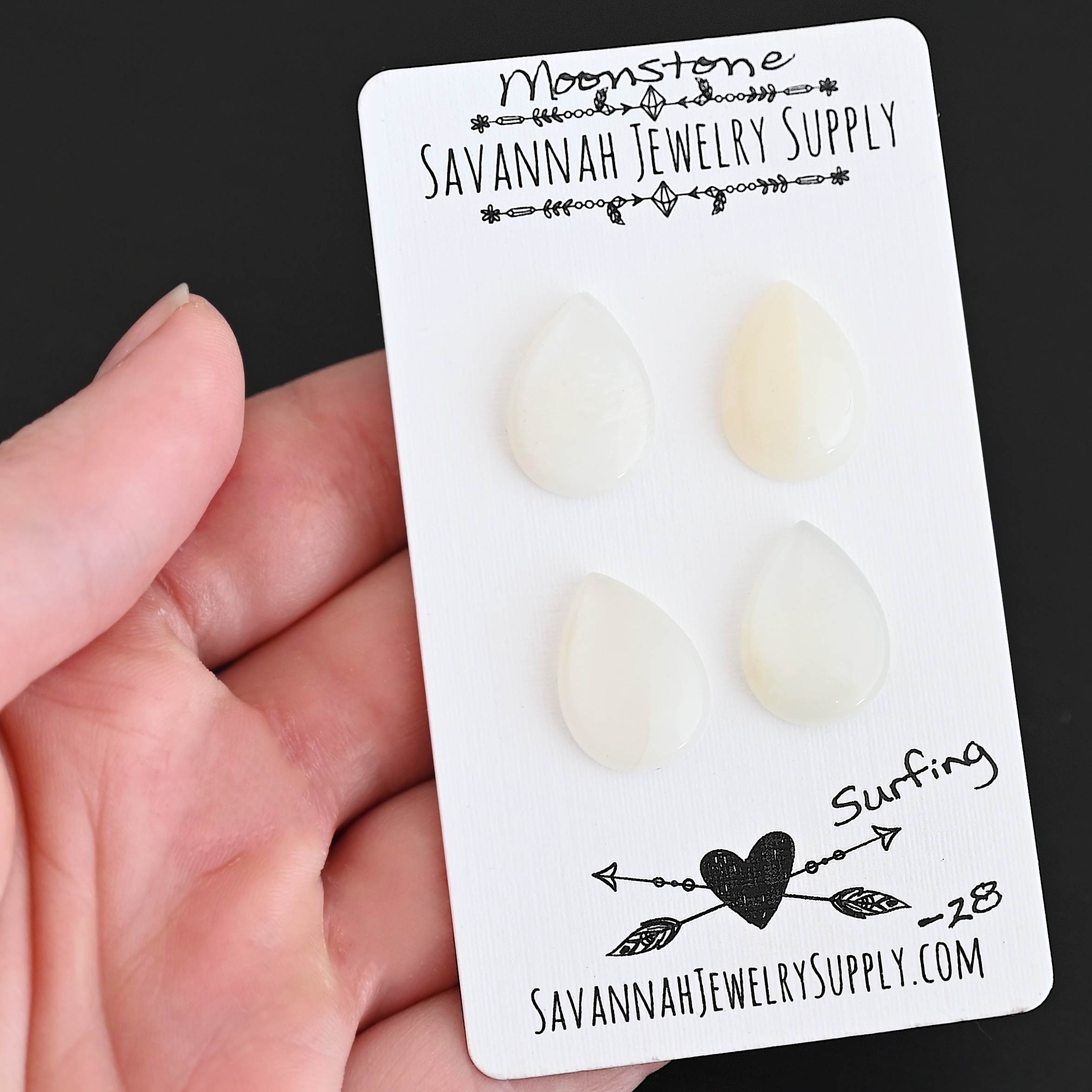 Surfing Moonstone Cabochon Parcel shown in hand