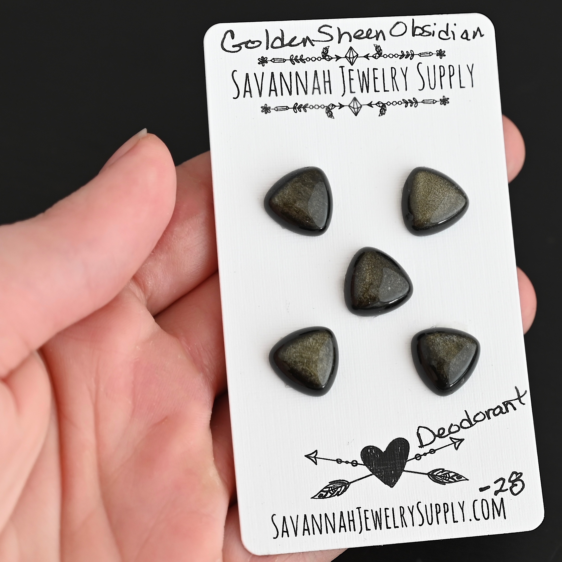 Deodorant Golden Sheen Obsidian Cabochon Parcel shown in hand