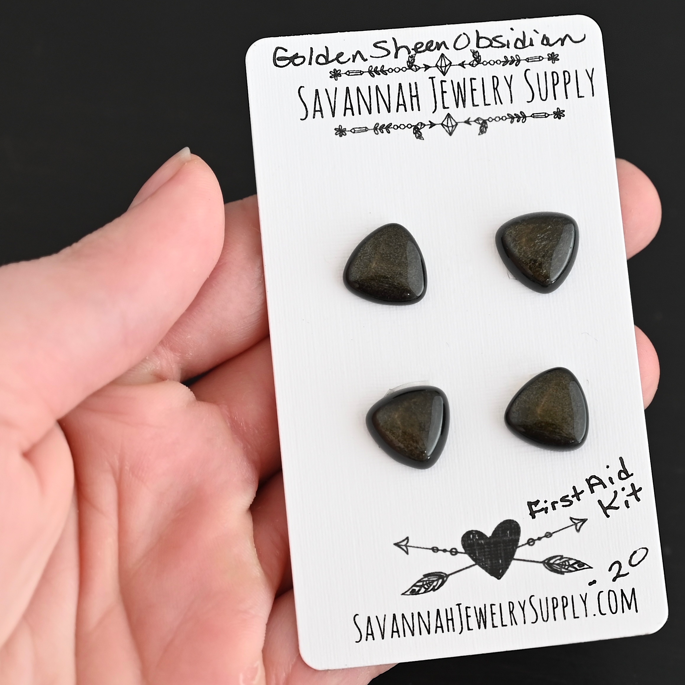 First Aid Kit Golden Sheen Obsidian Cabochon Parcel shown in hand