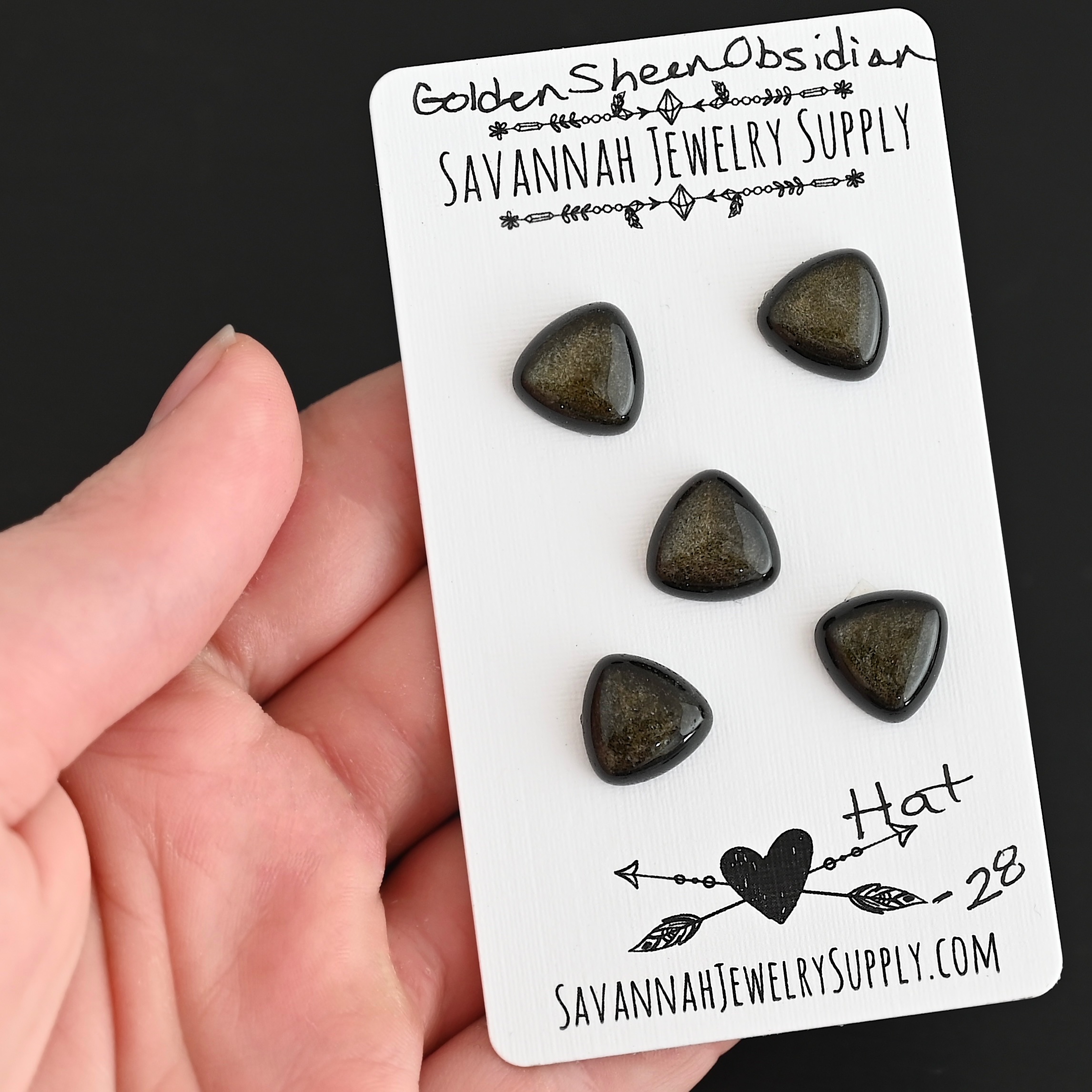 Hat Golden Sheen Obsidian Cabochon Parcel shown in hand