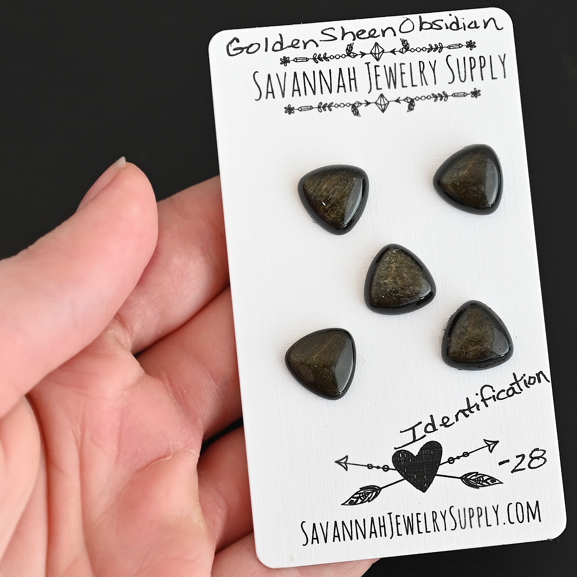 Identification Golden Sheen Obsidian Cabochon Parcel shown in hand