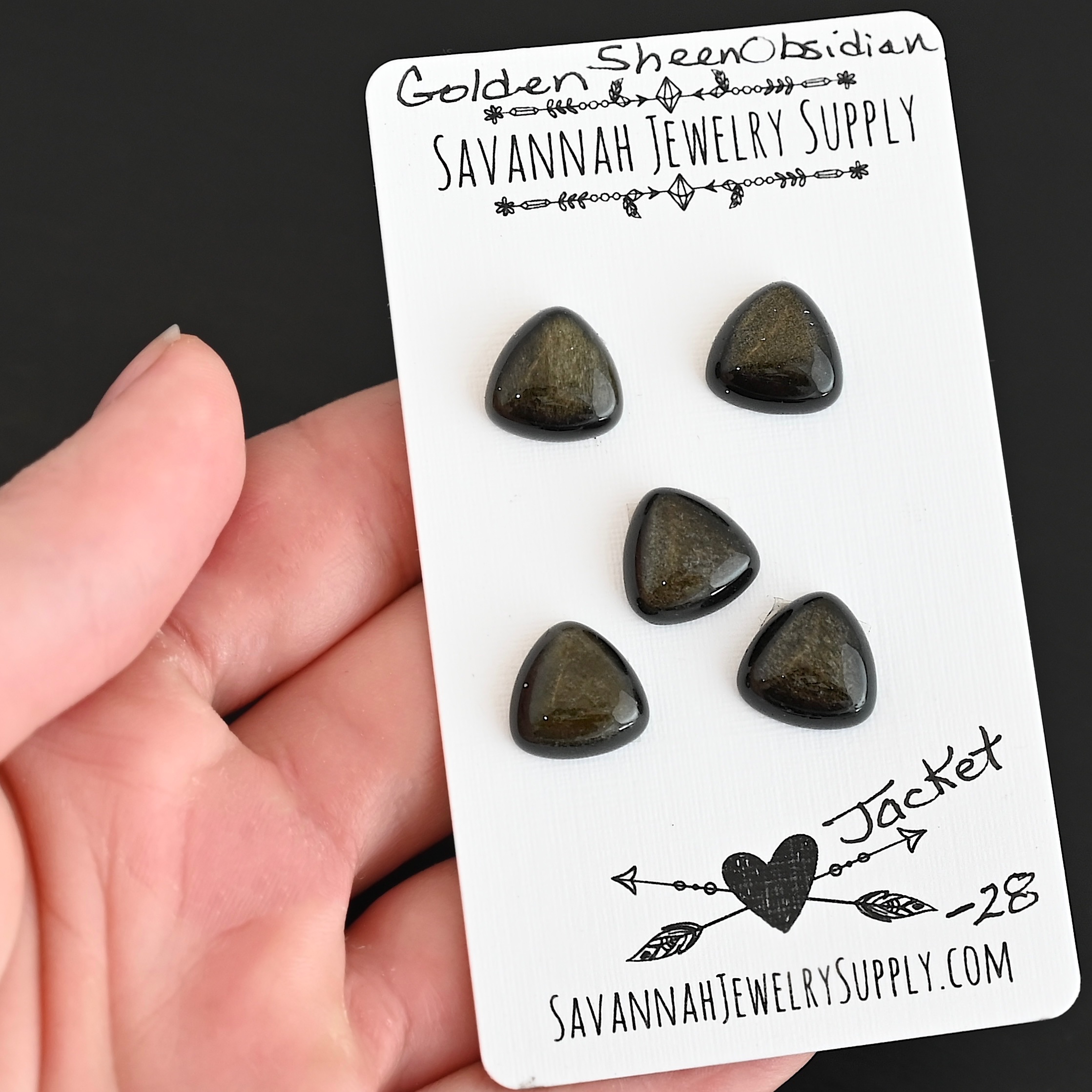 Jacket Golden Sheen Obsidian Cabochon Parcel shown in hand