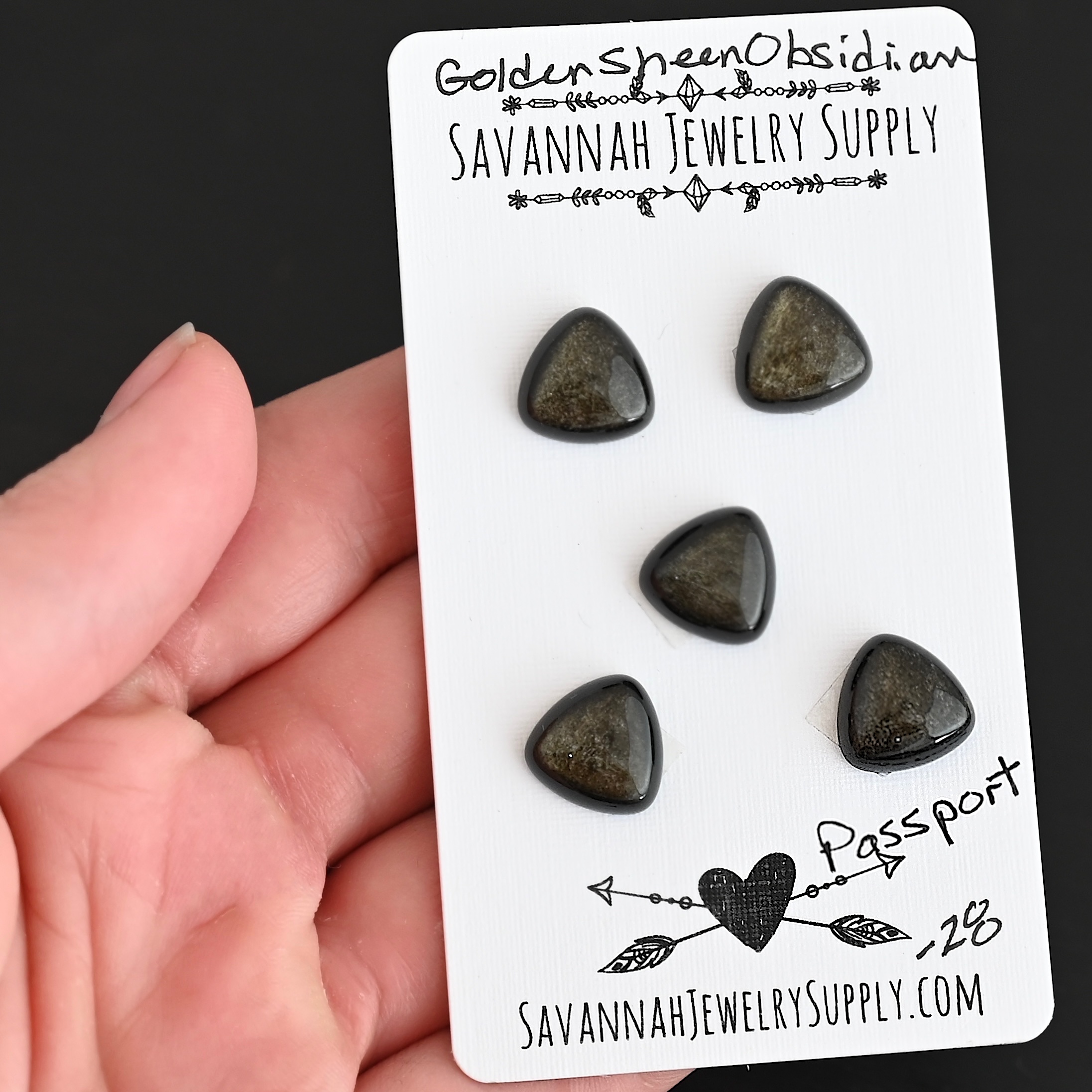 Passport Golden Sheen Obsidian Cabochon Parcel shown in hand