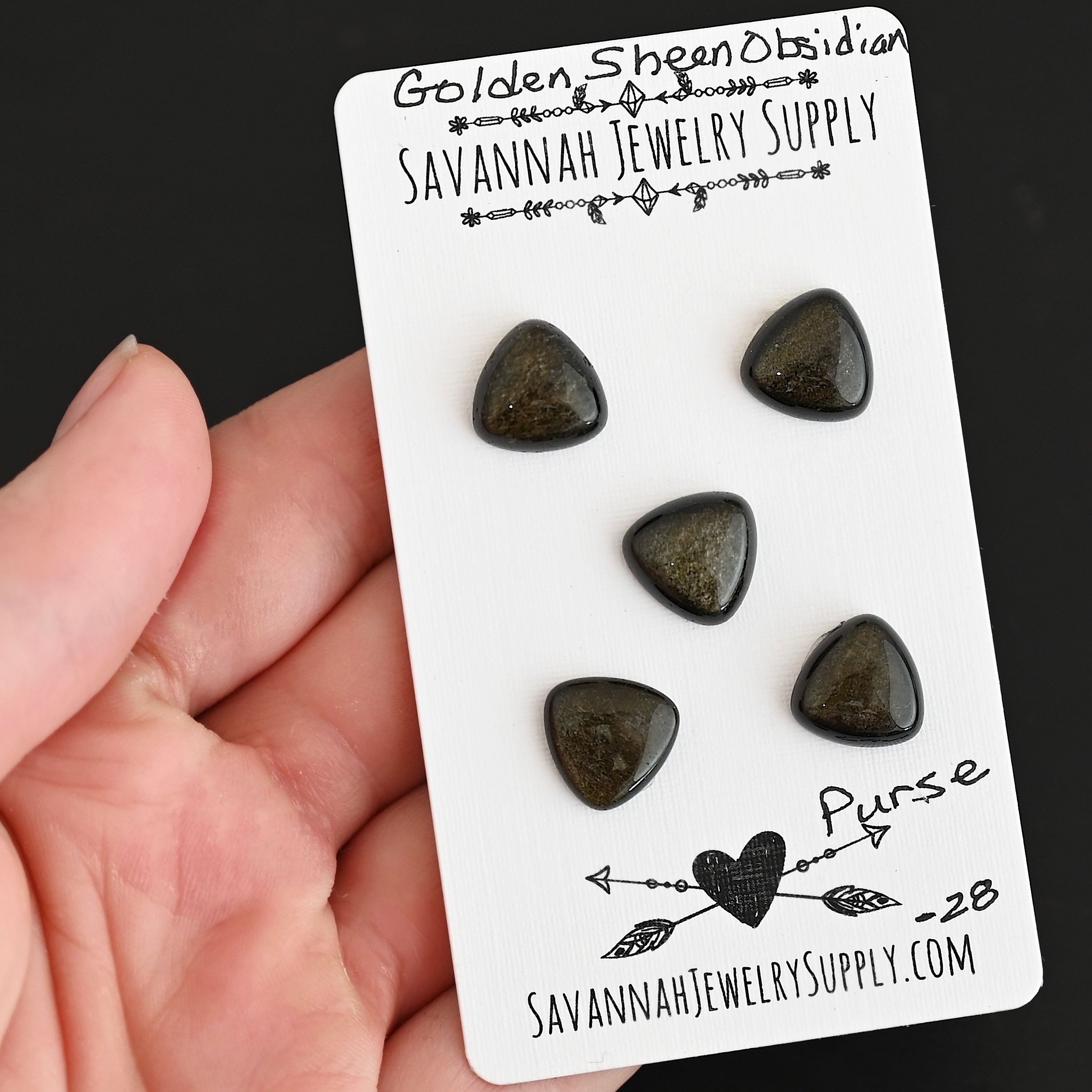 Purse Golden Sheen Obsidian Cabochon Parcel shown in hand