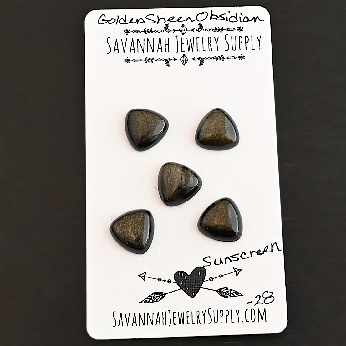 Sunscreen Golden Sheen Obsidian Cabochon Parcel shown on business card