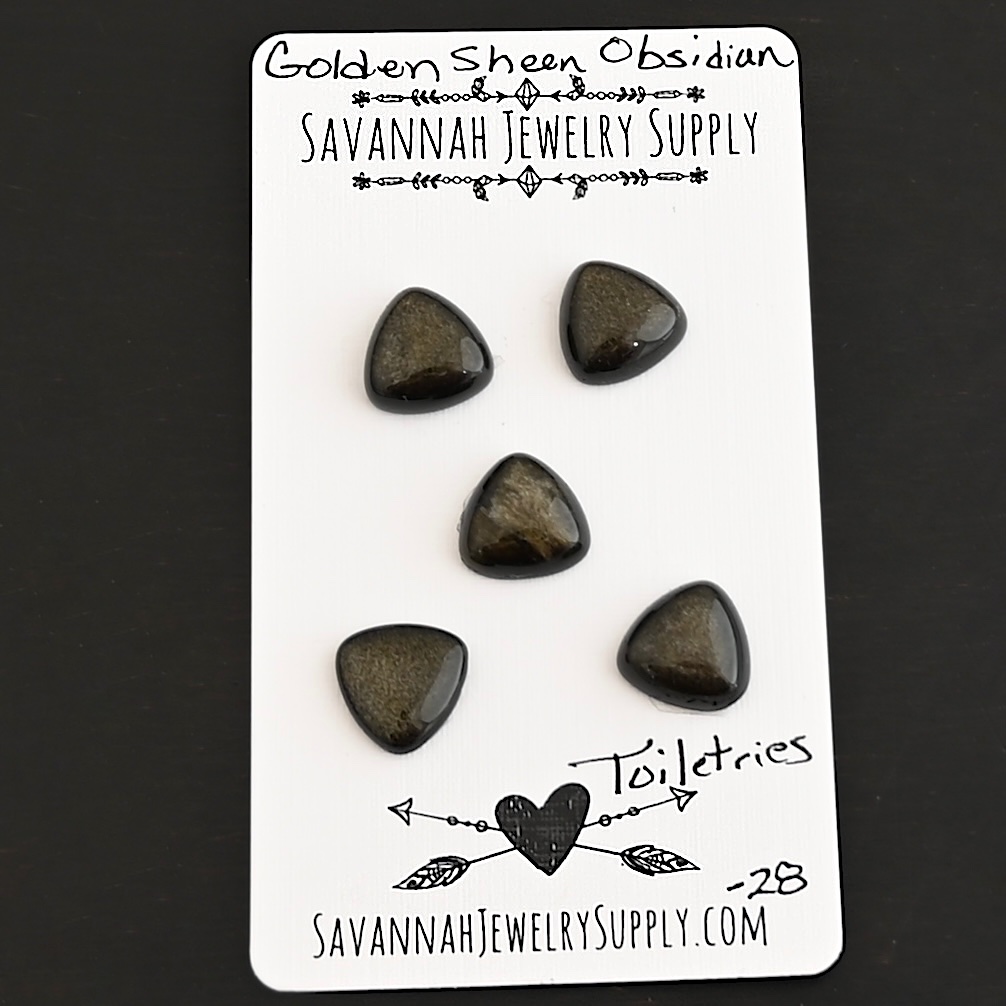 Toiletries Golden Sheen Obsidian Cabochon Parcel shown on business card
