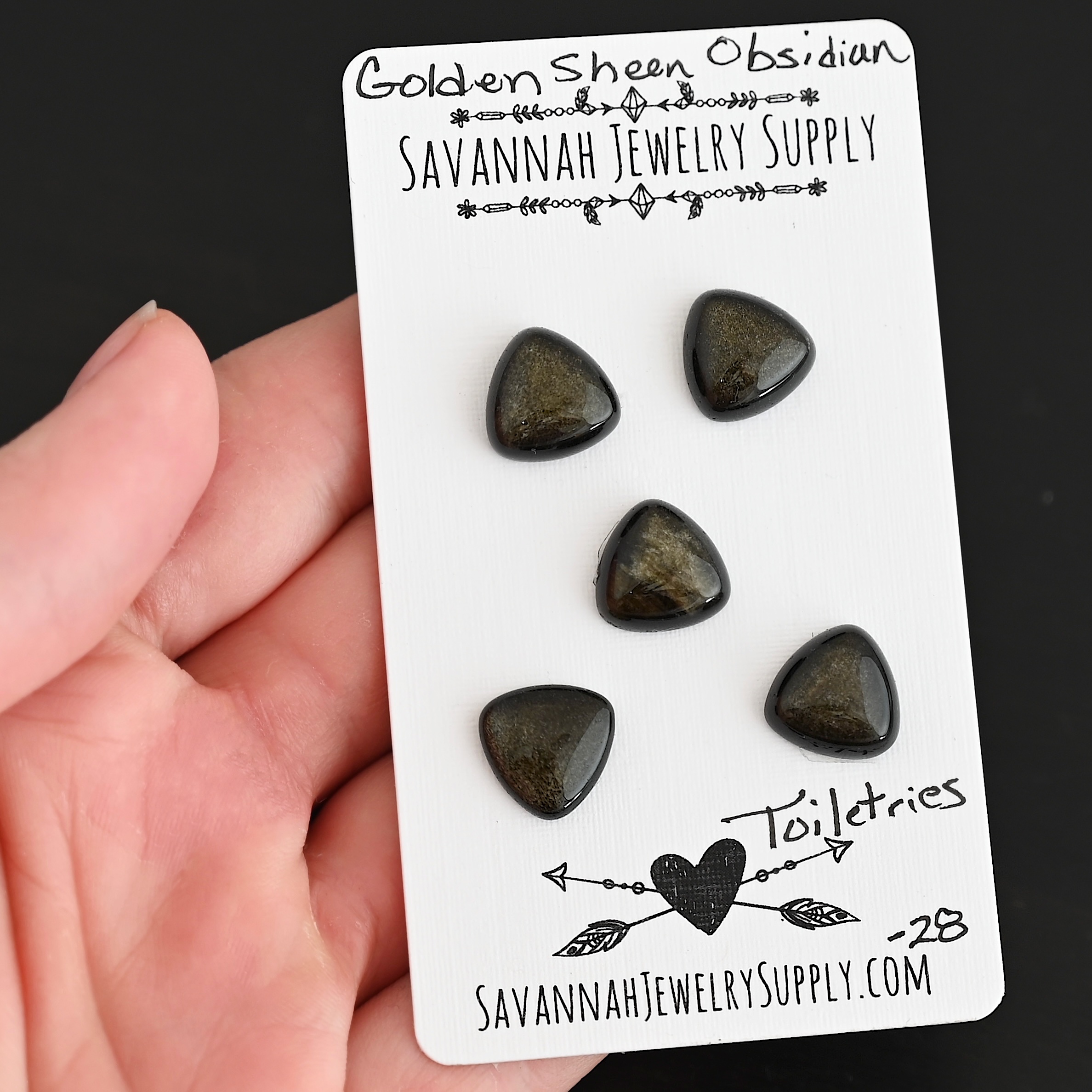 Toiletries Golden Sheen Obsidian Cabochon Parcel shown in hand