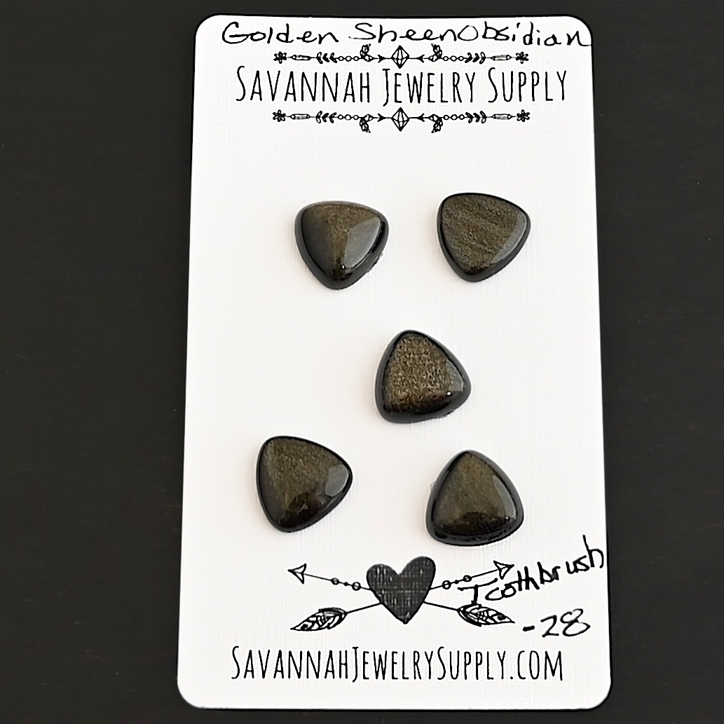 Toothbrush Golden Sheen Obsidian Cabochon Parcel shown on business card