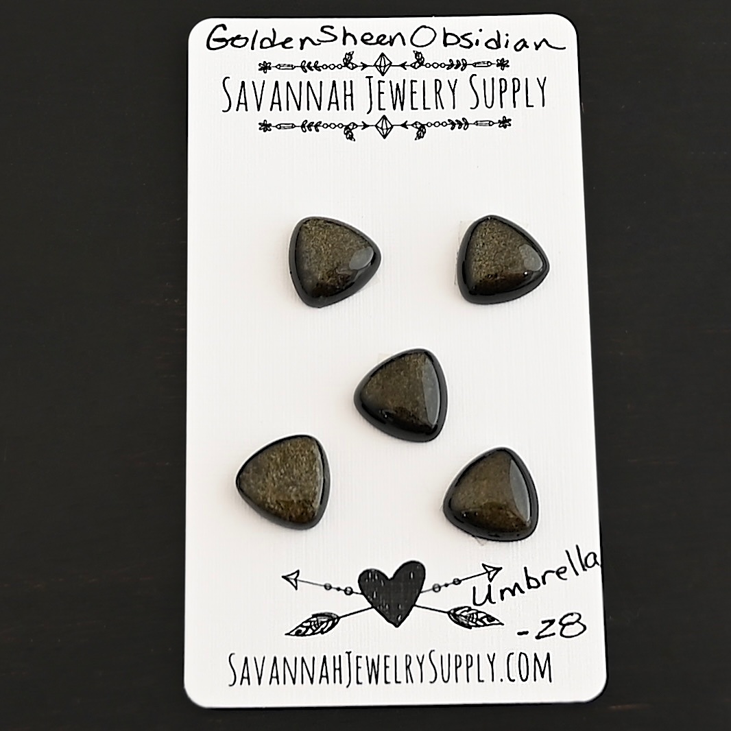 Umbrella Golden Sheen Obsidian Cabochon Parcel shown on business card