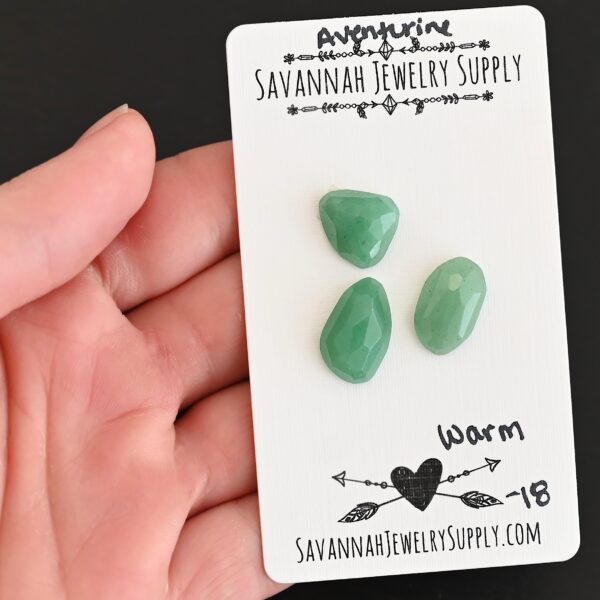 Warm Rose Cut Aventurine Cabochon Parcel shown in hand