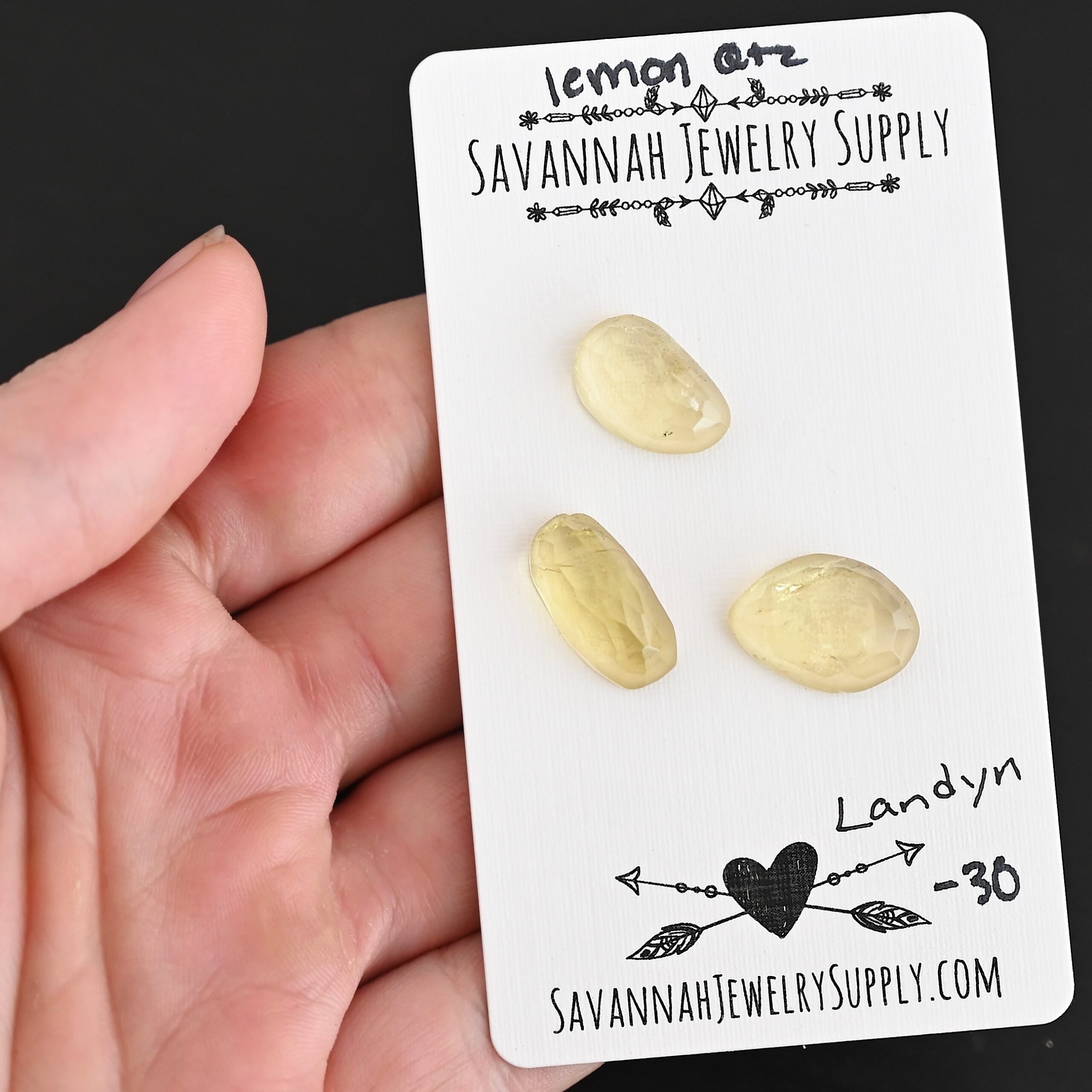 Landyn Rose Cut Lemon Quartz Cabochon Parcel shown in hand