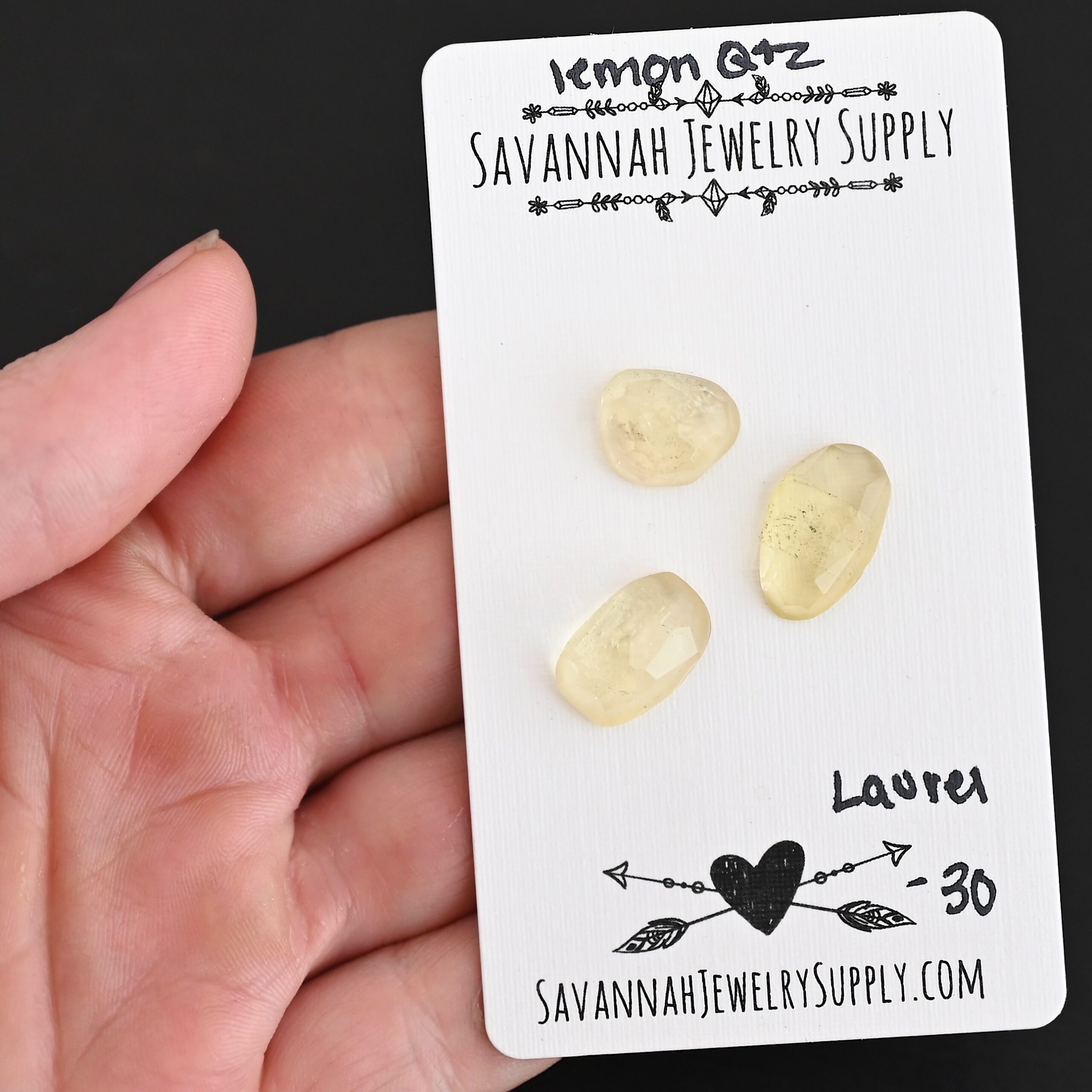 Laurel Rose Cut Lemon Quartz Cabochon Parcel shown in hand