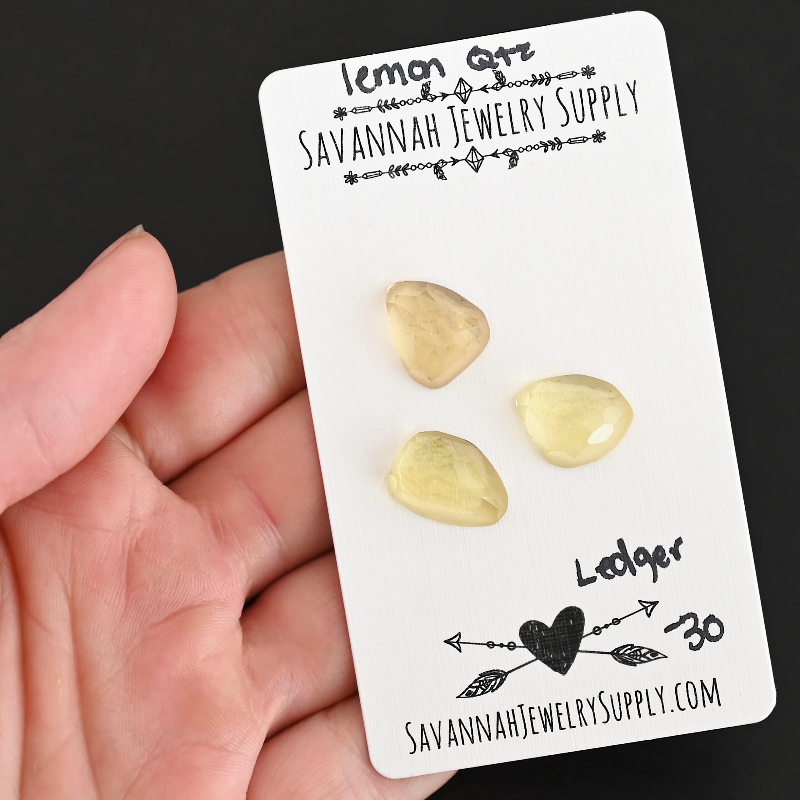 Ledger Rose Cut Lemon Quartz Cabochon Parcel shown in hand