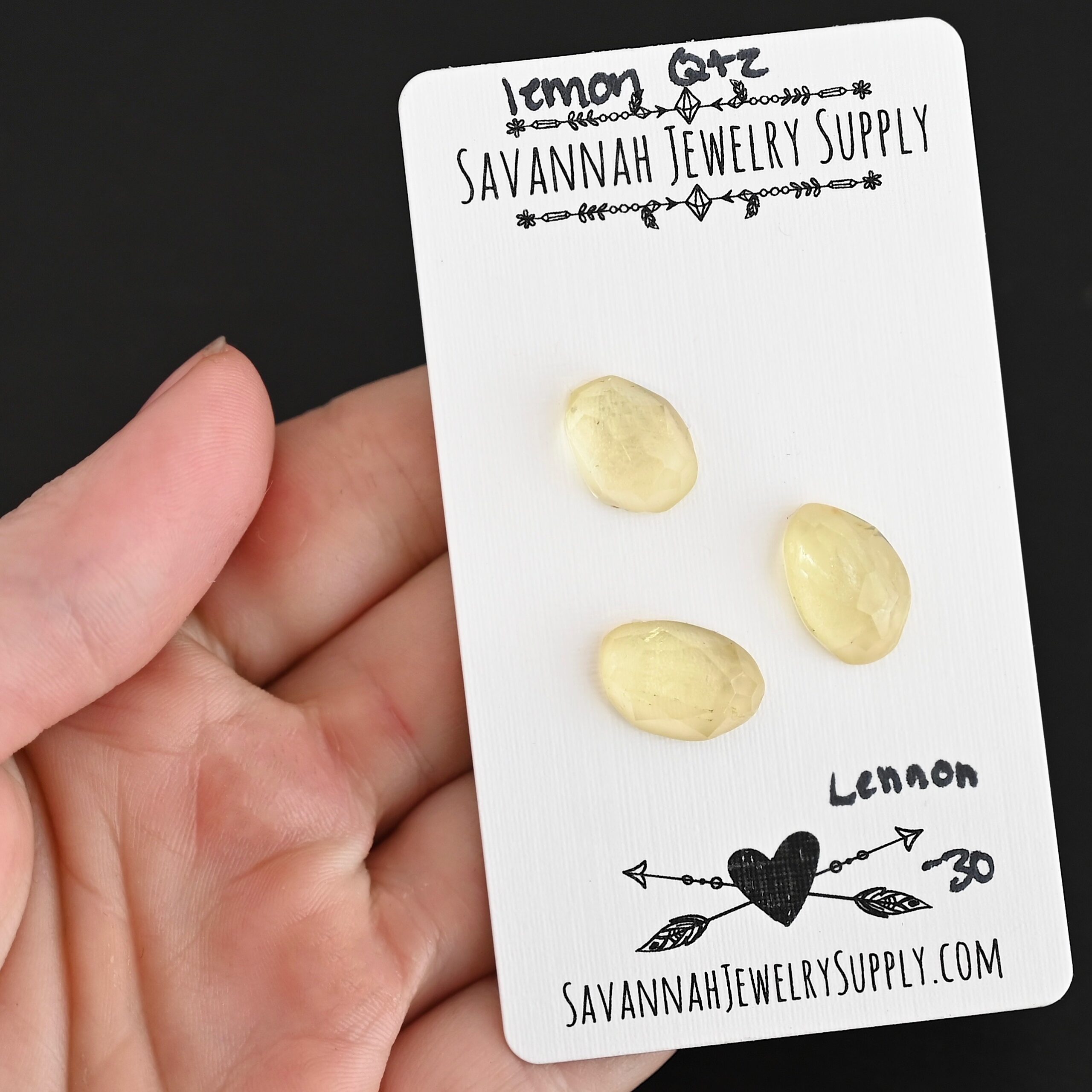 Lennon Rose Cut Lemon Quartz Cabochon Parcel shown in hand