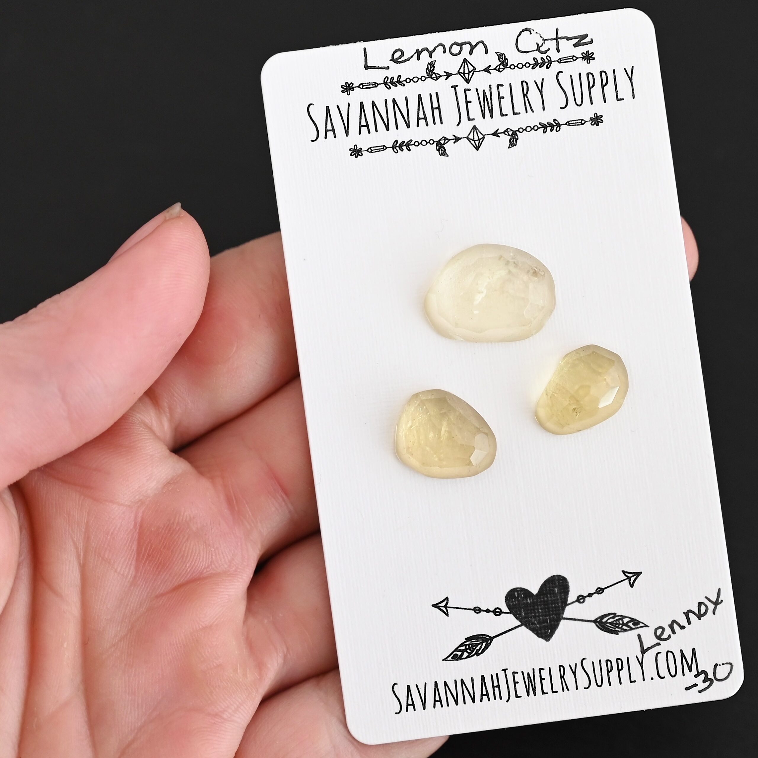 Lennox Rose Cut Lemon Quartz Cabochon Parcel shown in hand